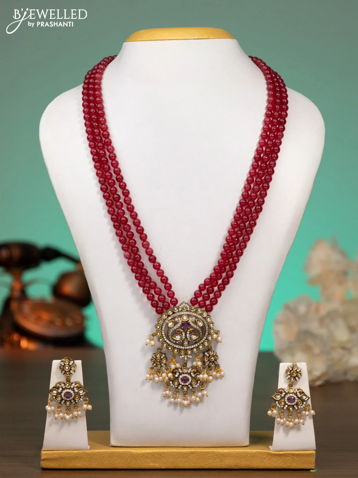 Beaded maroon necklace with ruby & cz stones and beads hanging in victorian finish