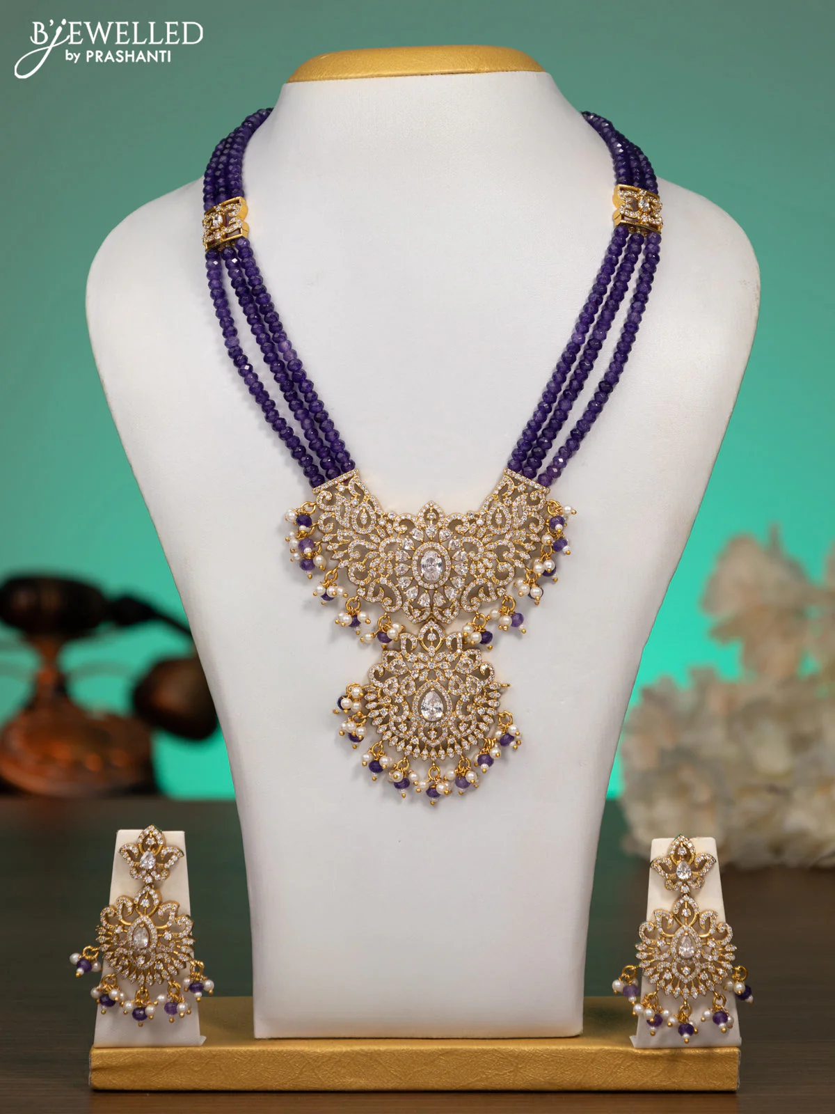 Beaded violet necklace with cz stones and beads hanging in antique finish