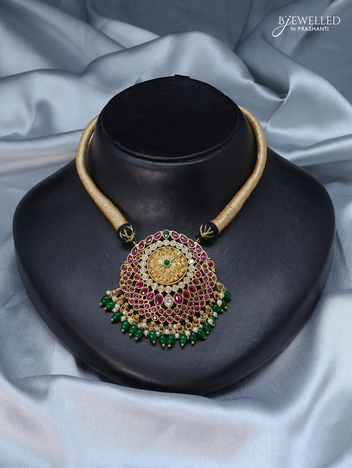 Black thread necklace with kemp stone and green beads hanging - Image 2