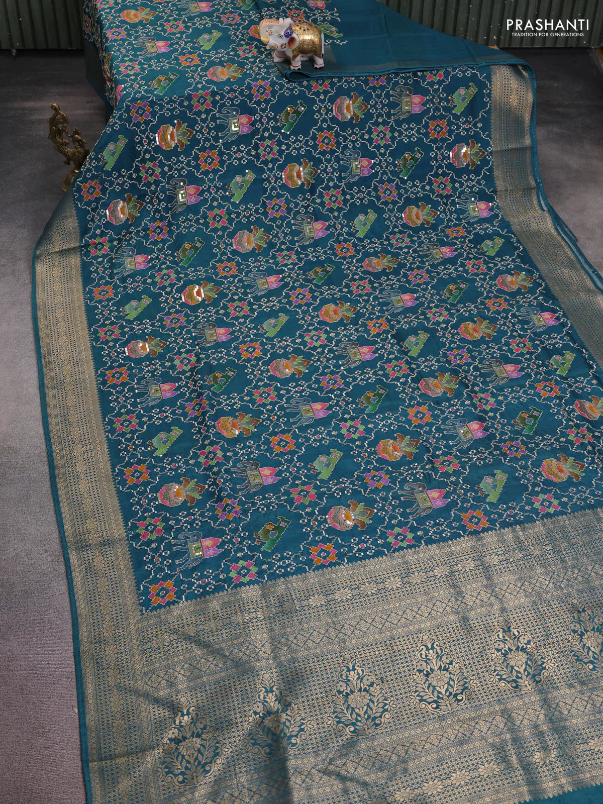 Crepe silk saree peaccock blue with allover mina weaves & sequin work and zari woven border