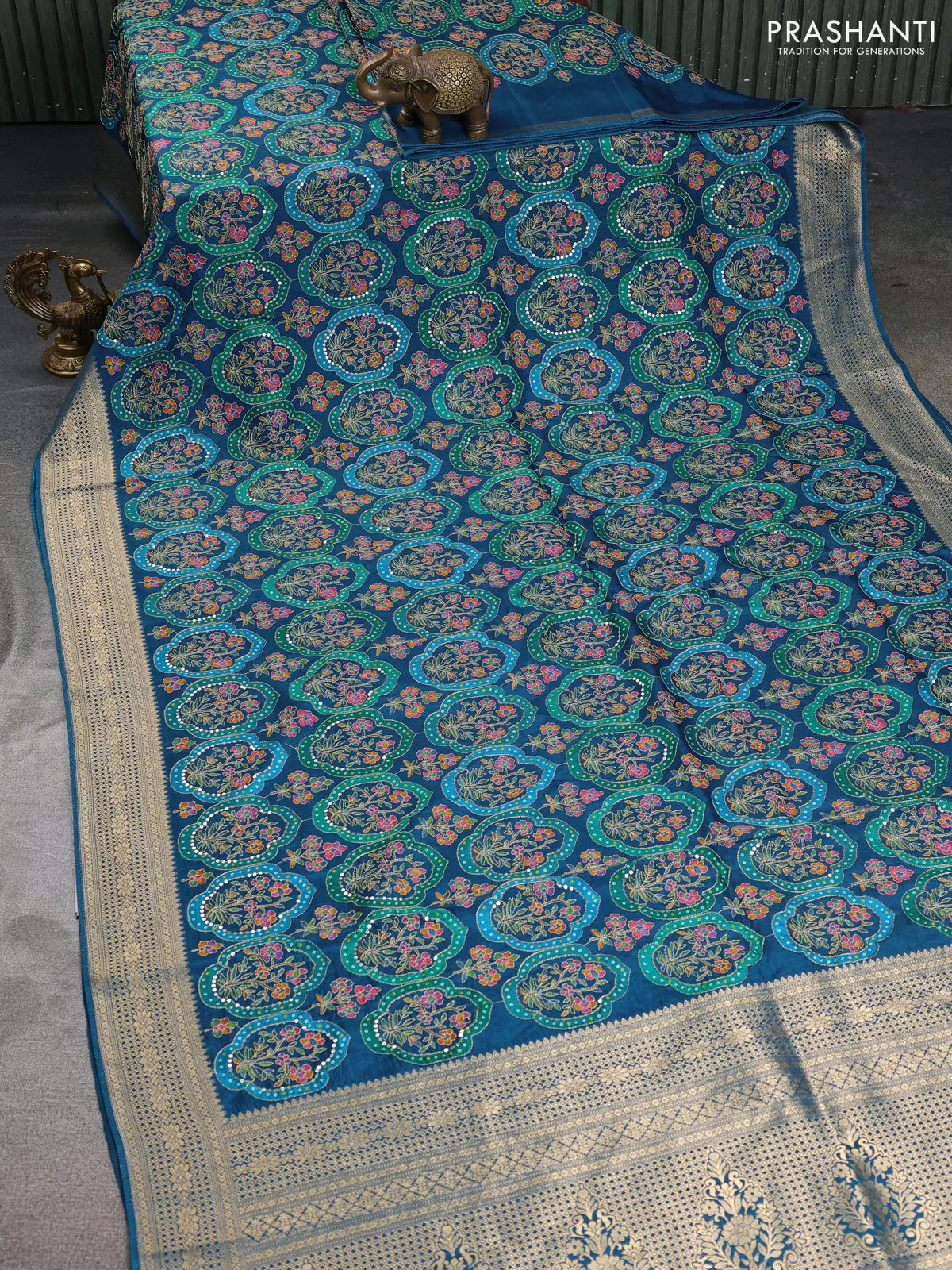 Crepe silk saree peacock blue with allover mina weaves & sequin work and zari woven border