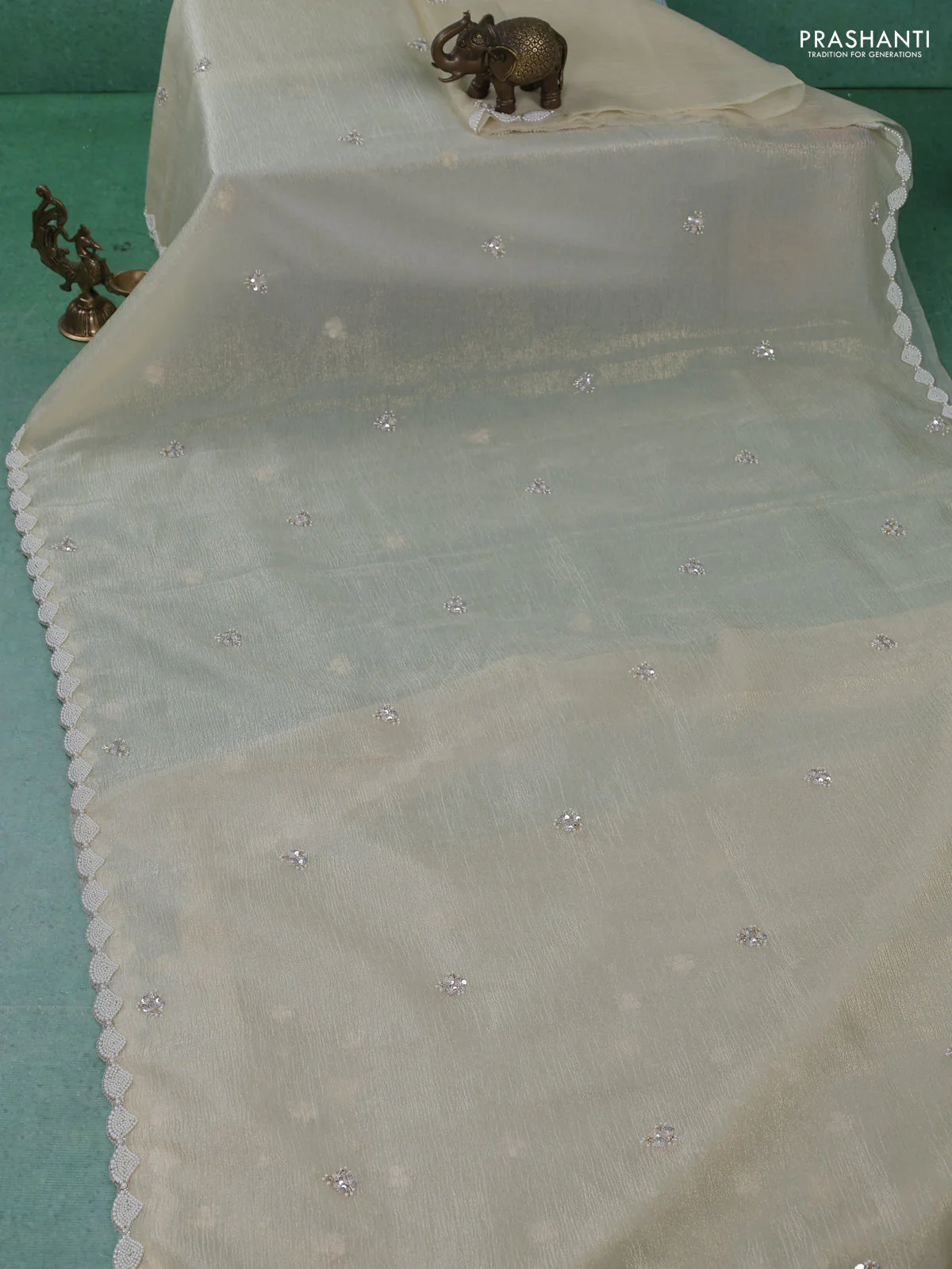 Crush tissue saree cream with sequin work buttas and beaded work border - Image 2