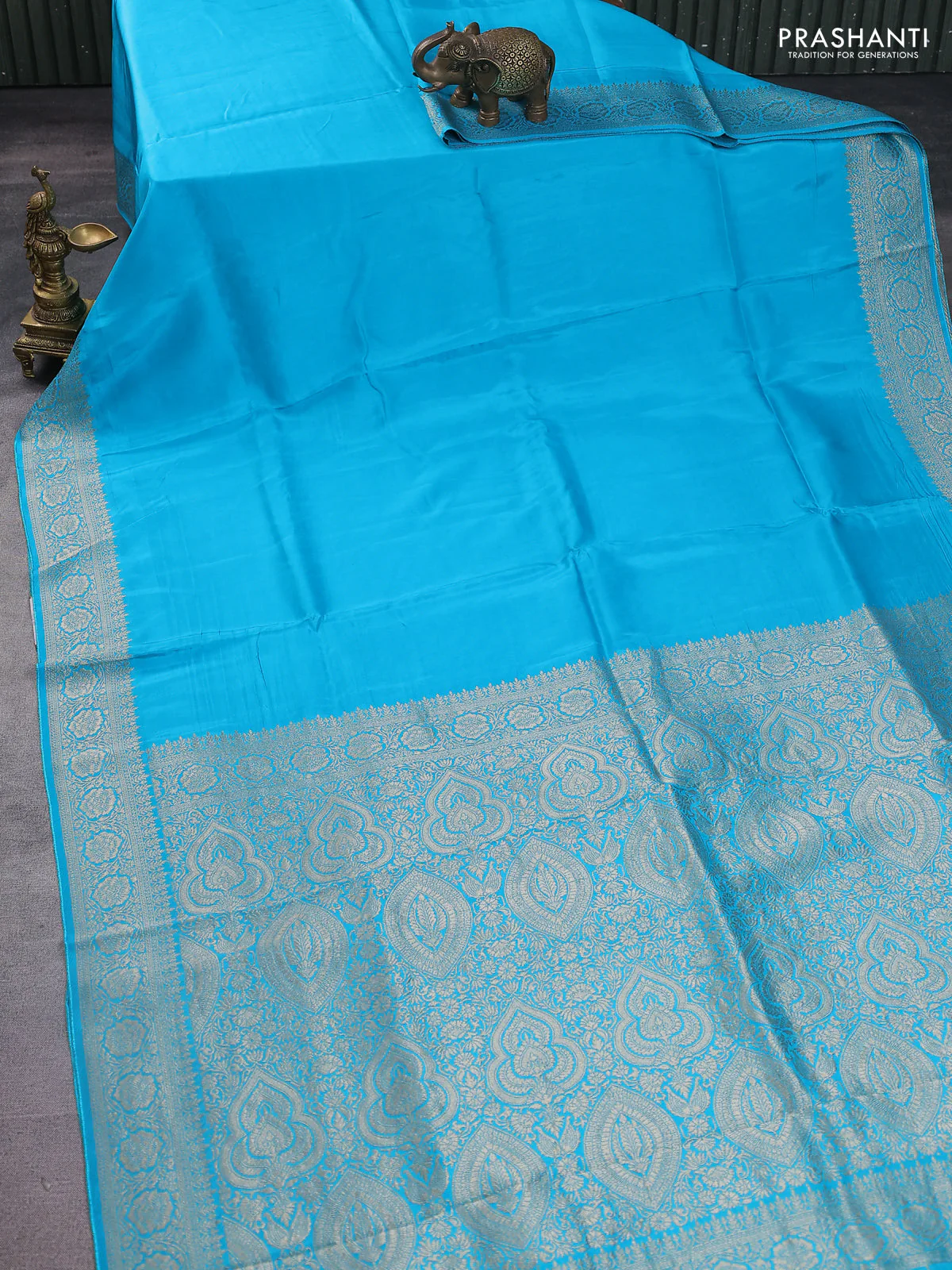 Dola silk saree teal blue with plain body and zari woven border - Image 2