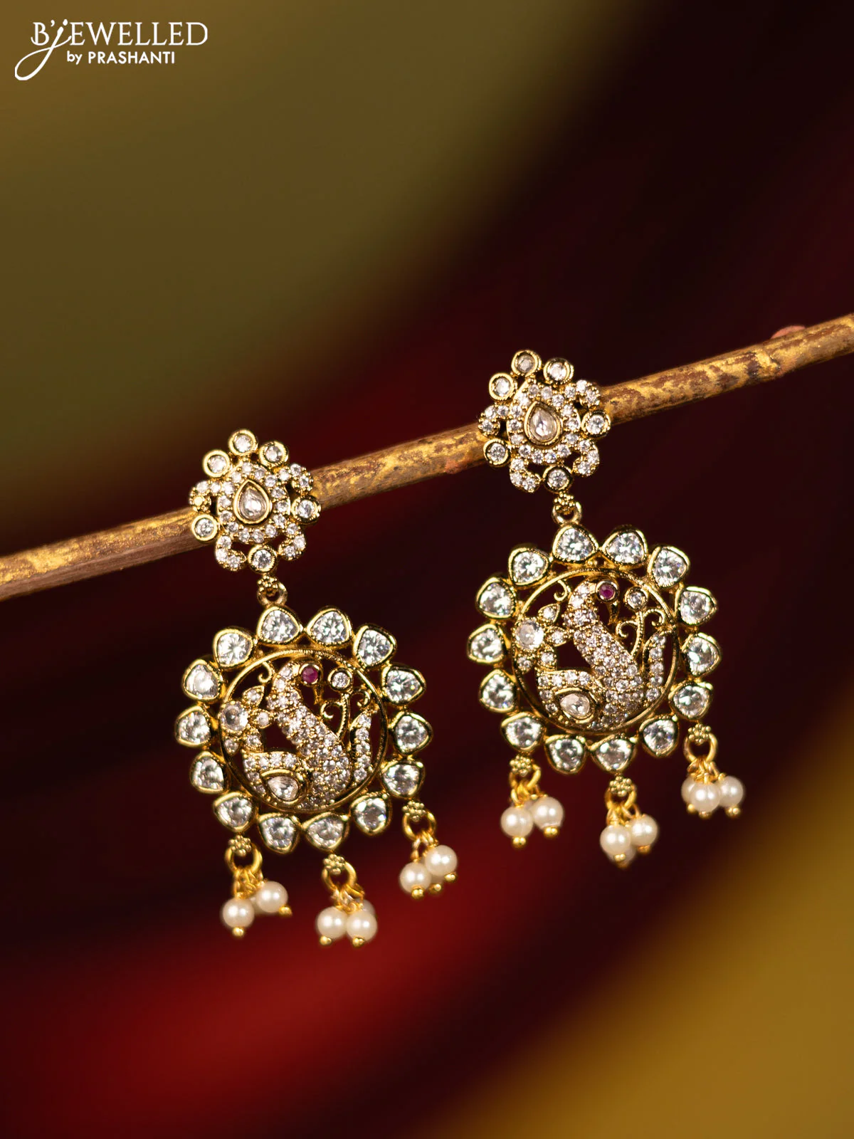 Earrings peacock design with cz stones and pearl hangings in victorian finish