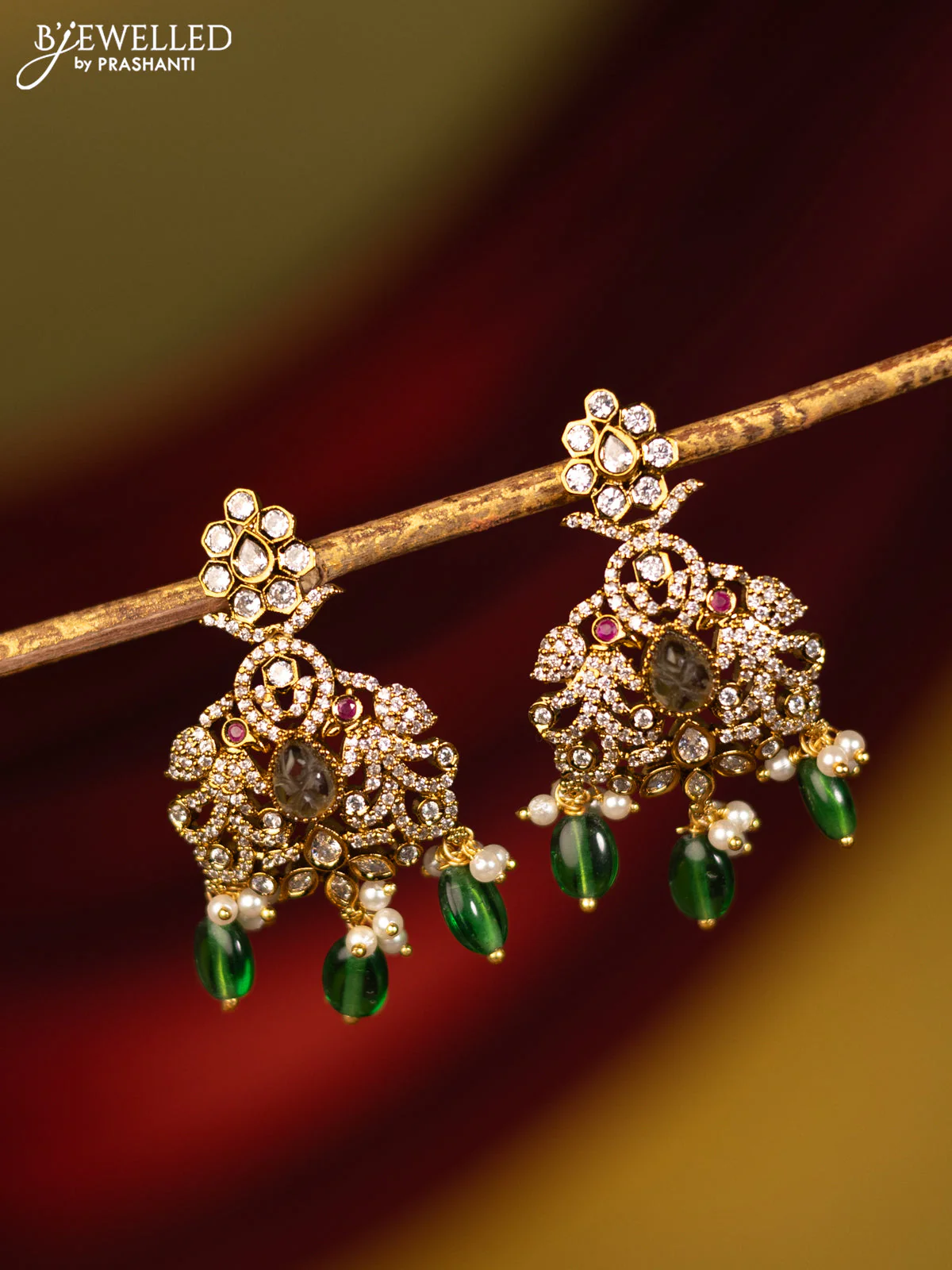 Earrings with cz stones and green beads hanging in victorian finish