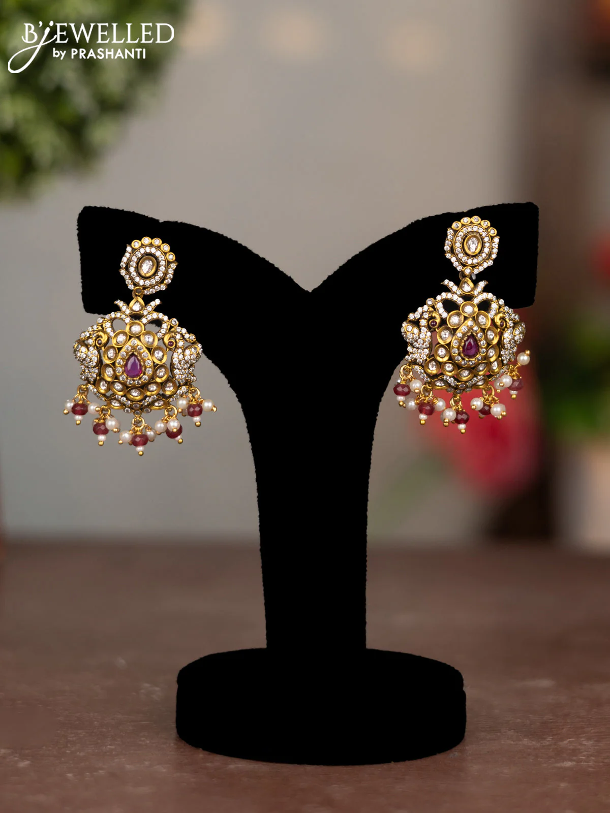 Earrings with ruby & cz stones and pearl hangings in victorian finish