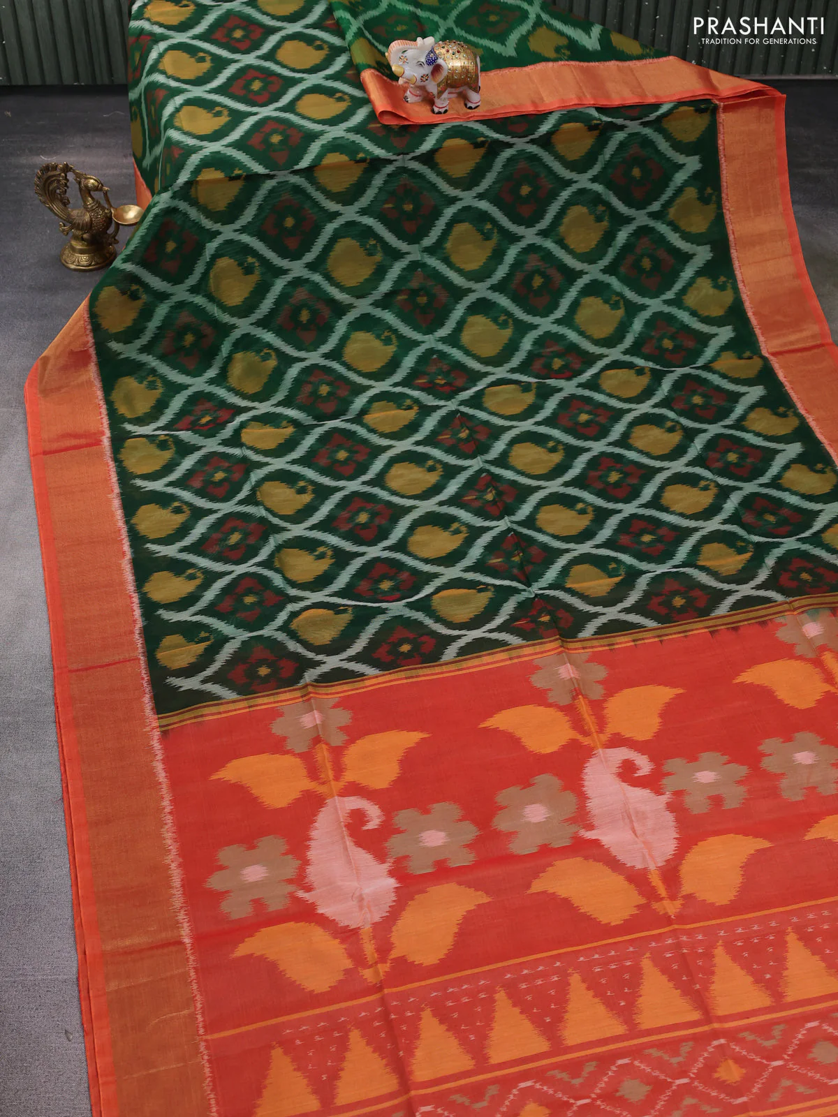 Ikat silk cotton saree bottle green and orange with allover ikat weaves and zari woven border - Image 2