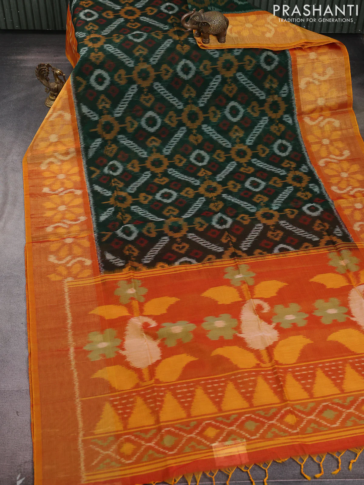 Ikat silk cotton saree bottle green and rustic orange with allover ikat weaves and long zari woven ikat border - Image 2