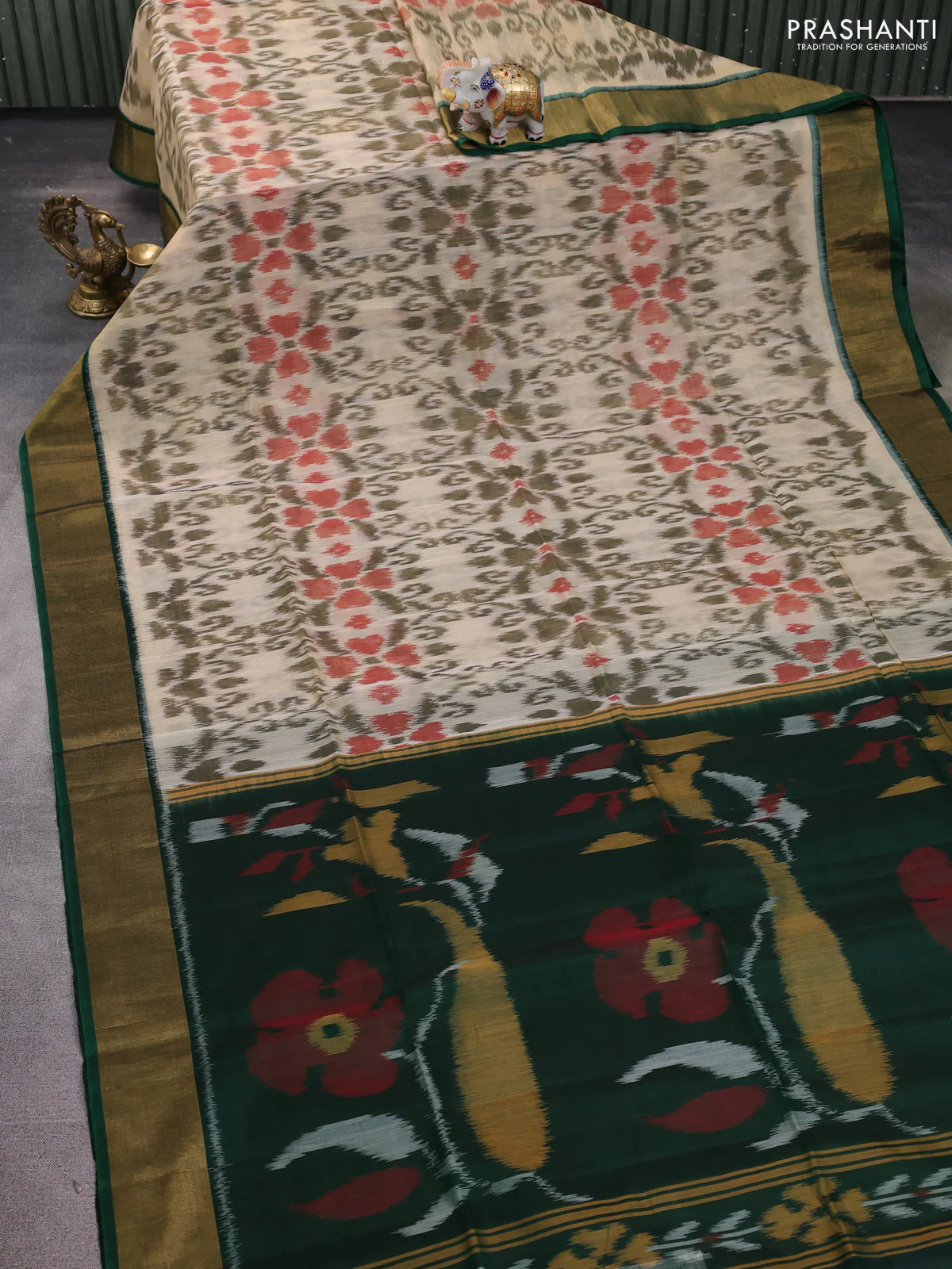 Ikat silk cotton saree cream and dark green with allover ikat weaves and zari woven border - Image 2