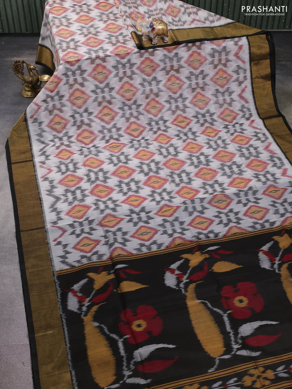 Ikat silk cotton saree off white and black with allover ikat weaves and zari woven border - Image 2