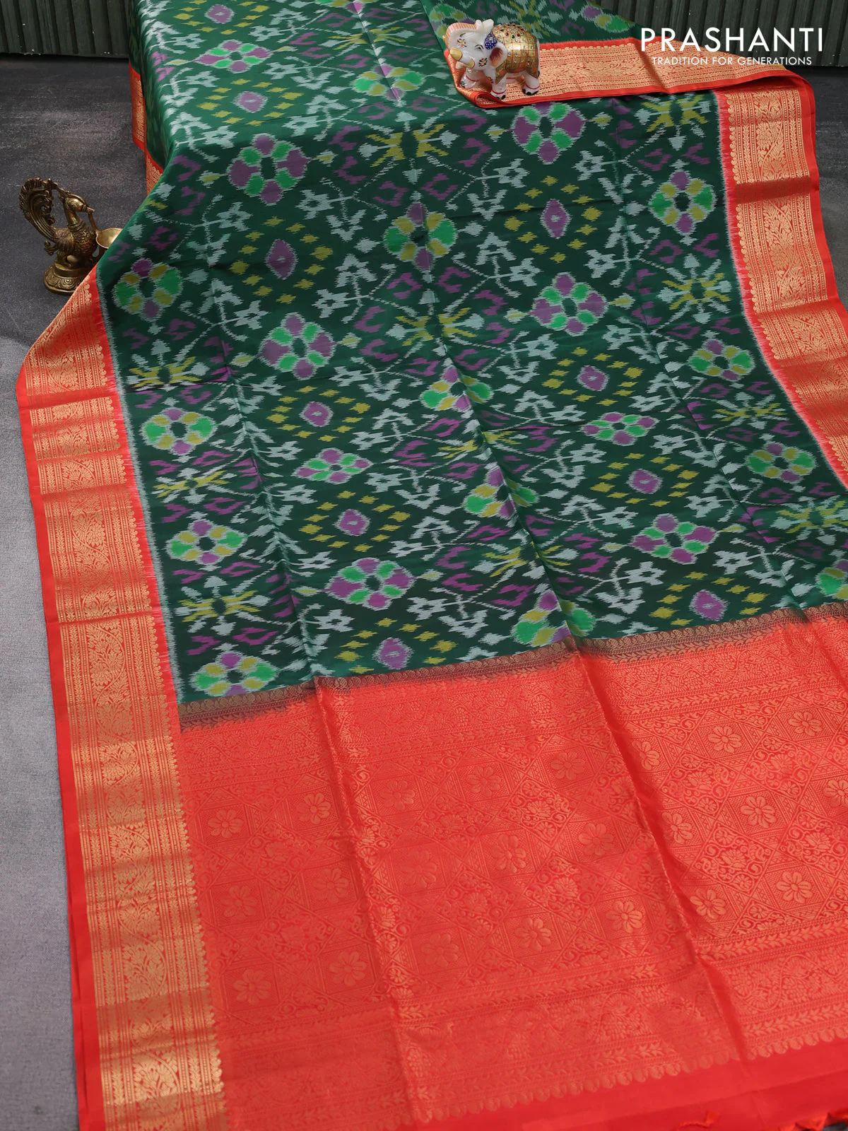 Ikat soft silk saree dark green and orange with allover ikat weaves and zari woven border - Image 2
