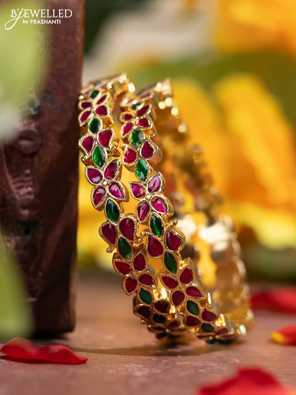 Jadau screw type bangle with floral design and jadau kemp stones