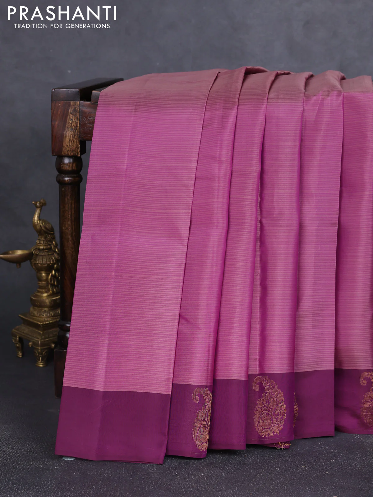 Kanchipuram silk saree purple shade and purple with plain body and paisley zari woven butta border