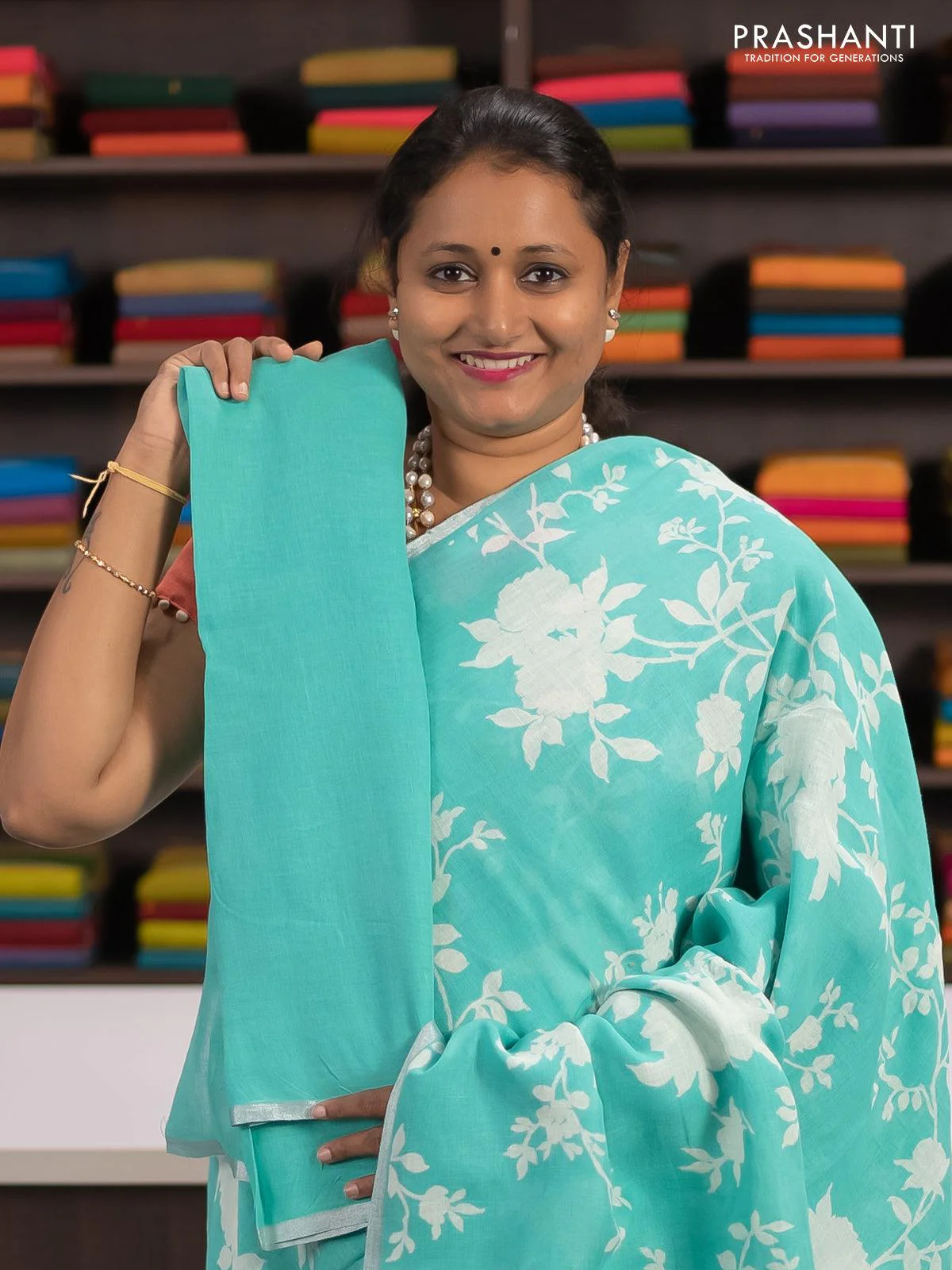 Linen cotton saree teal blue with allover floral prints and small silver zari woven border - Image 3