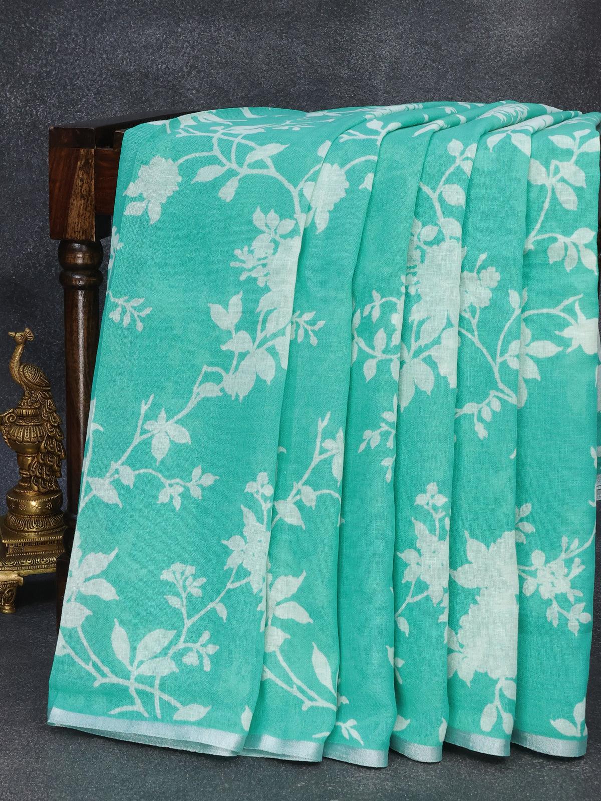 Linen cotton saree teal blue with allover floral prints and small silver zari woven border - Image 4