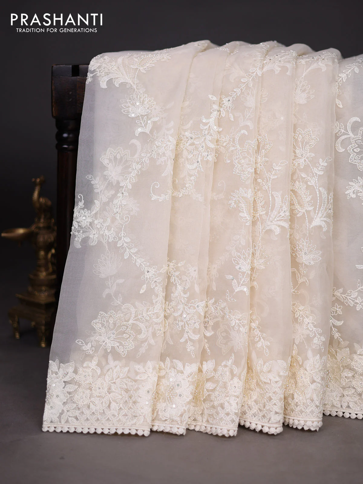 Organza silk saree cream with allover floral embroidery sequin work and crocia lace work border