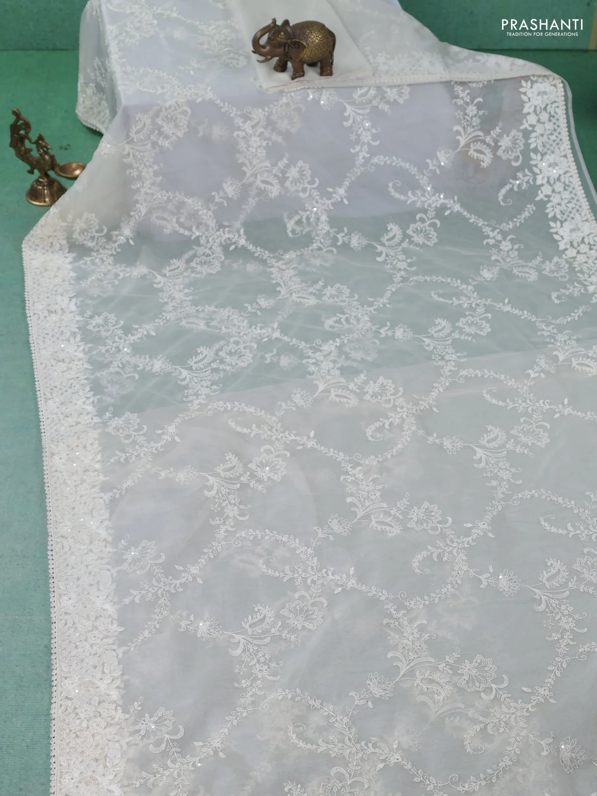 Organza silk saree cream with allover floral embroidery sequin work and crocia lace work border - Image 2