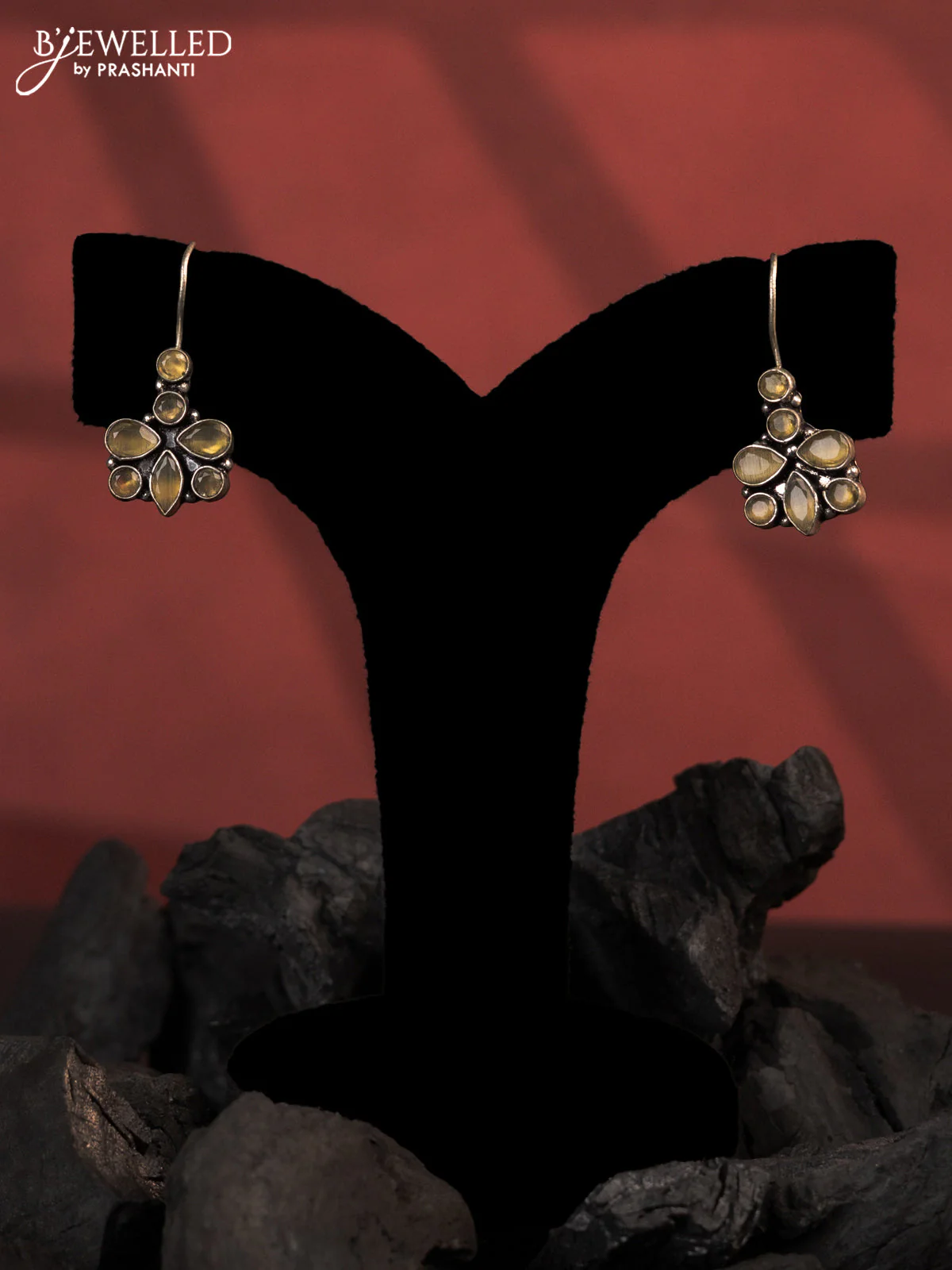 Oxidised hanging type earrings with yellow stones