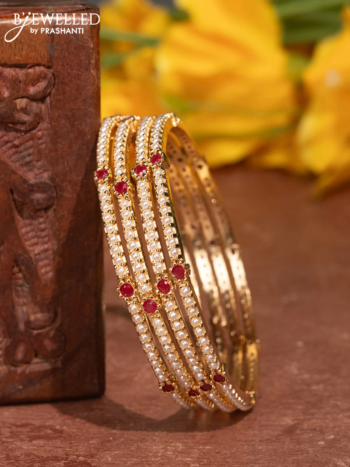 Pearl bangles with ruby stones and pearls in gold finish