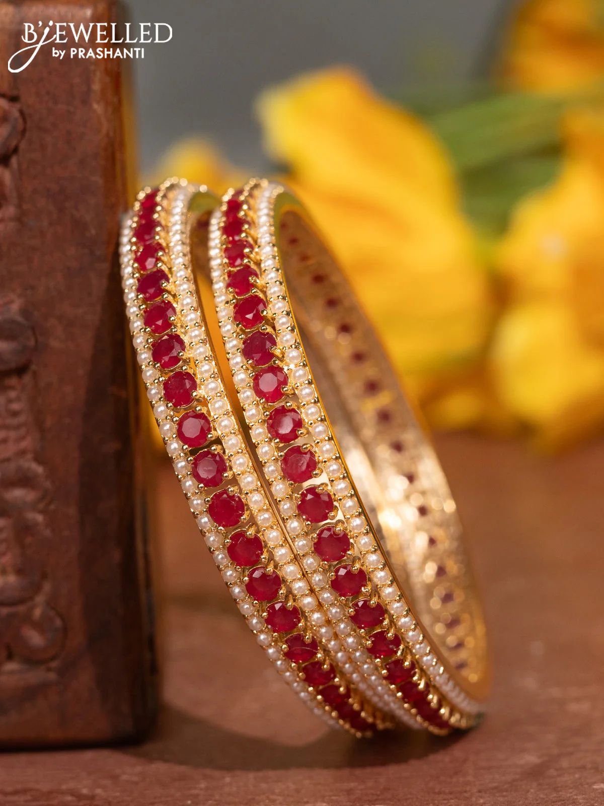 Pearl bangles with ruby stones and pearls in gold finish