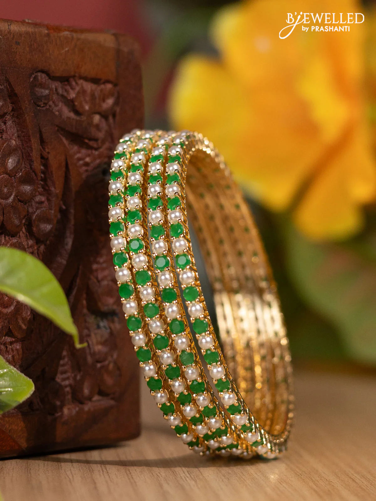 Pearl bangles with emerald stones and pearls in gold finish