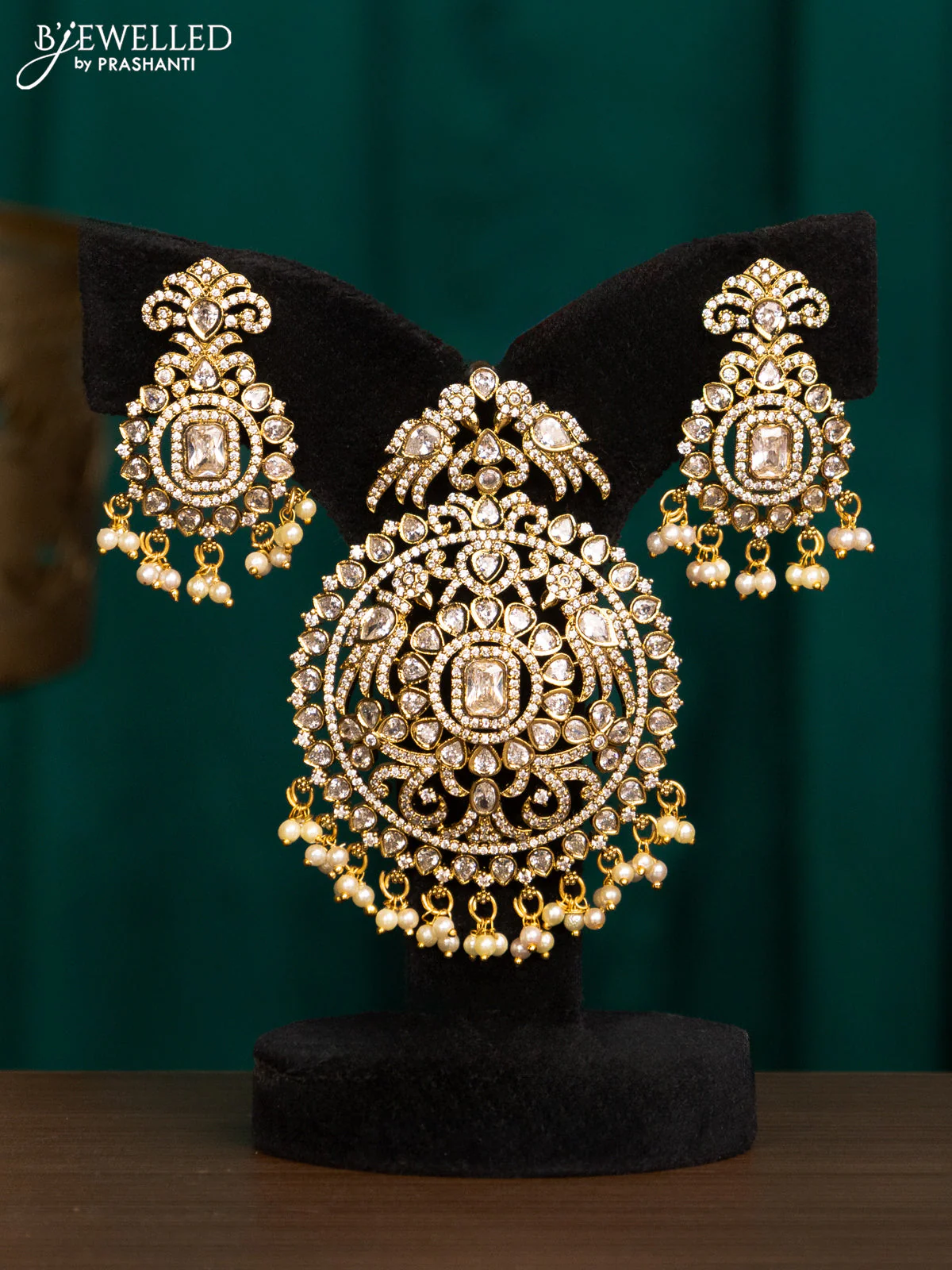 Pendant set with cz stones and beads hanging in victorian finish