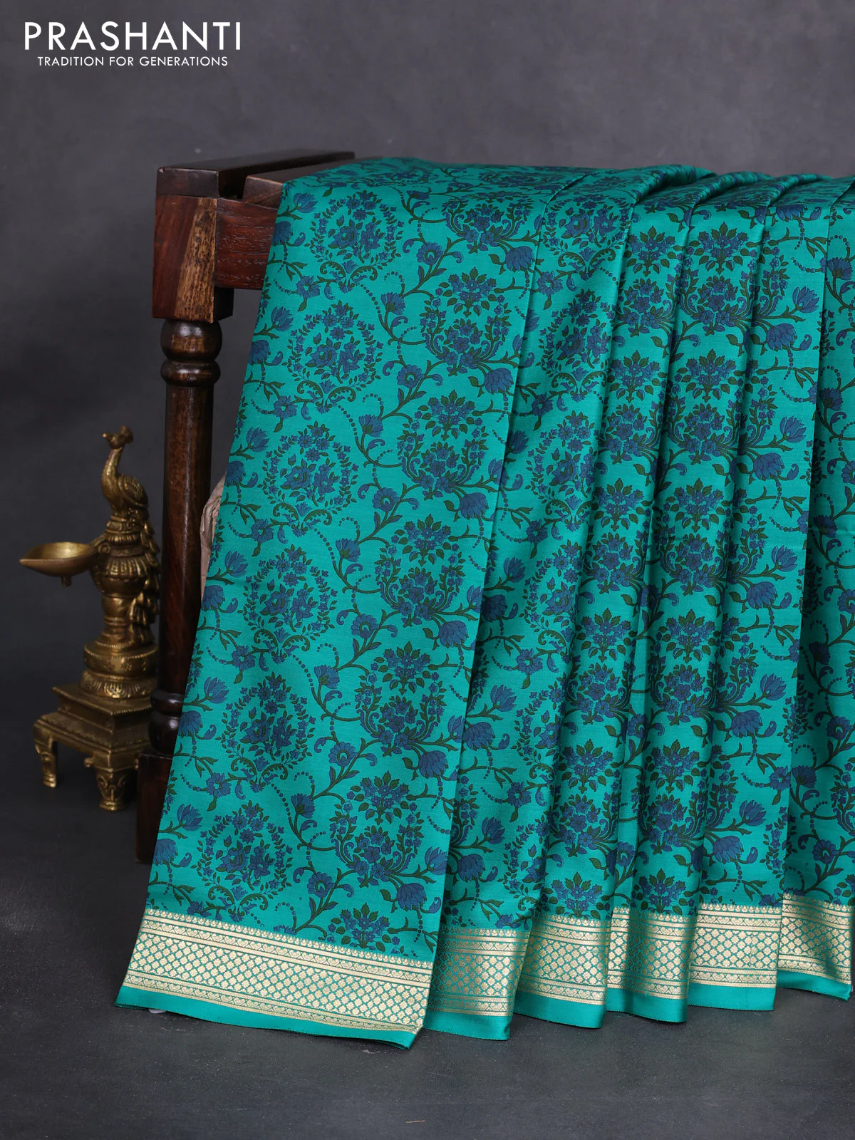 Printed silk saree teal green with allover prints and zari woven border