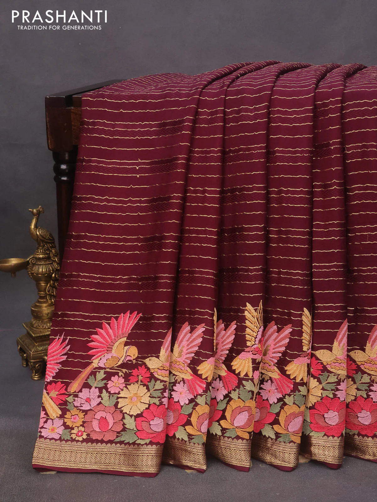 Pure crepe saree maroon with allover zari weaves & embroidery work and zari woven border