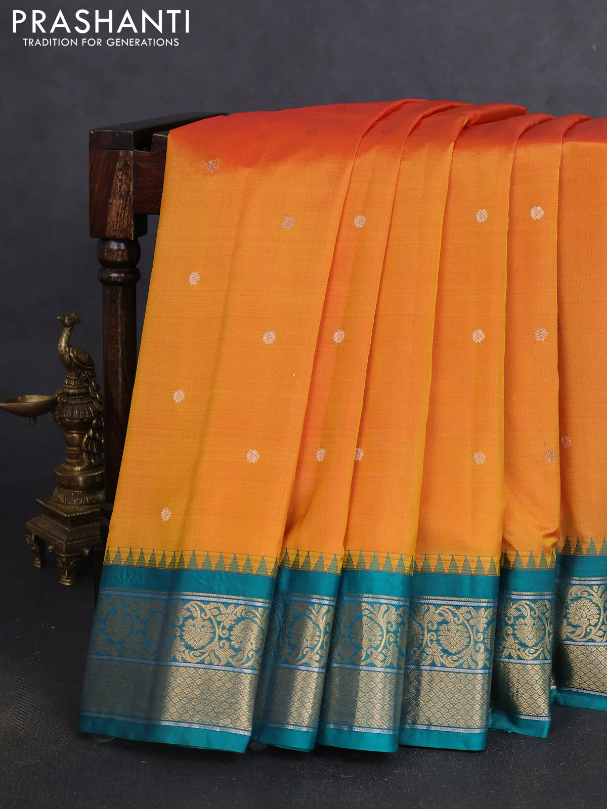 Pure gadwal silk saree dual shade of mustard yellowish pink and teal green with zari woven buttas and temple design zari woven korvai border
