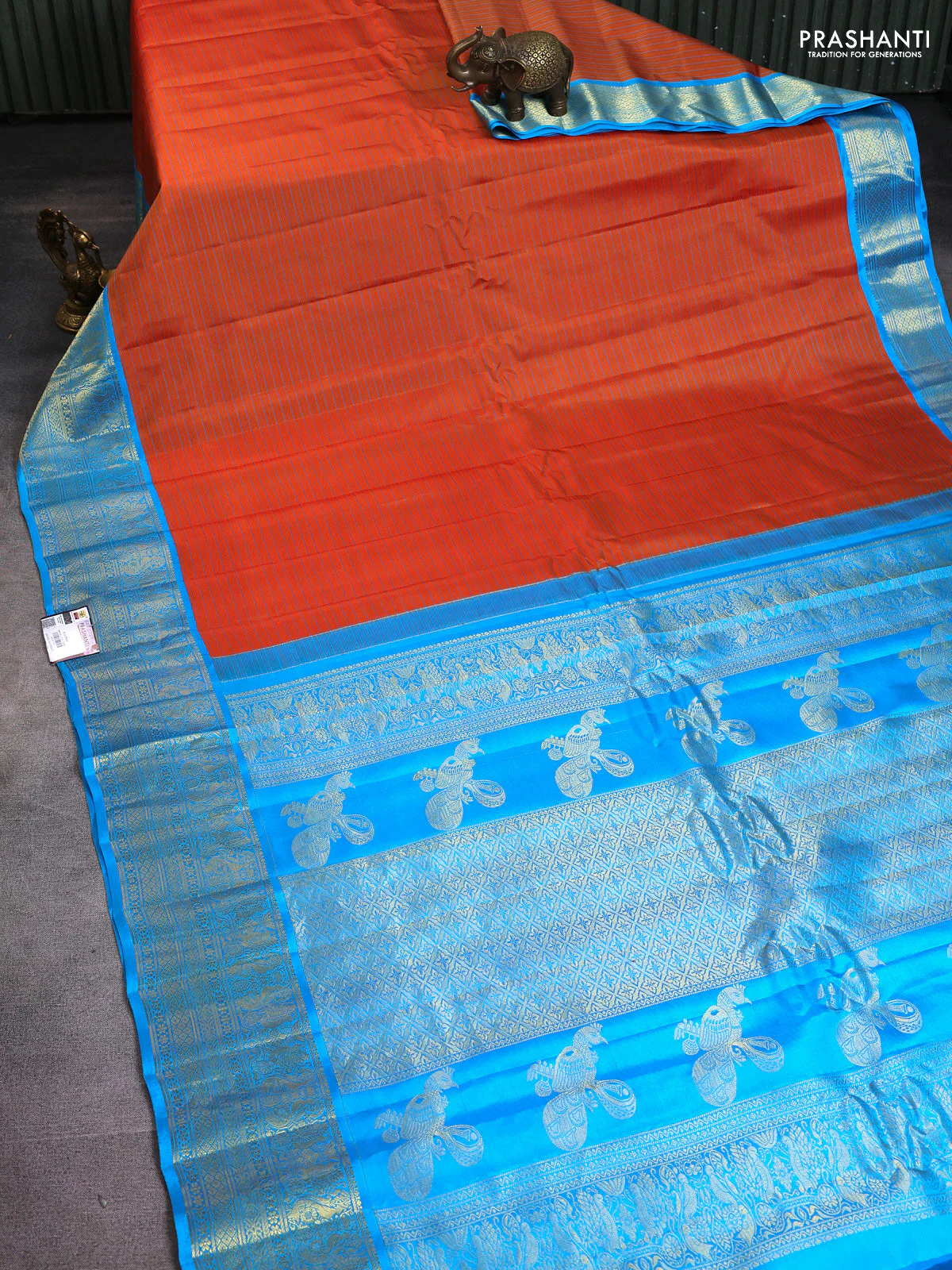 Pure gadwal silk saree rustic orange and blue with allover stripe pattern and rich zari woven border - Image 2