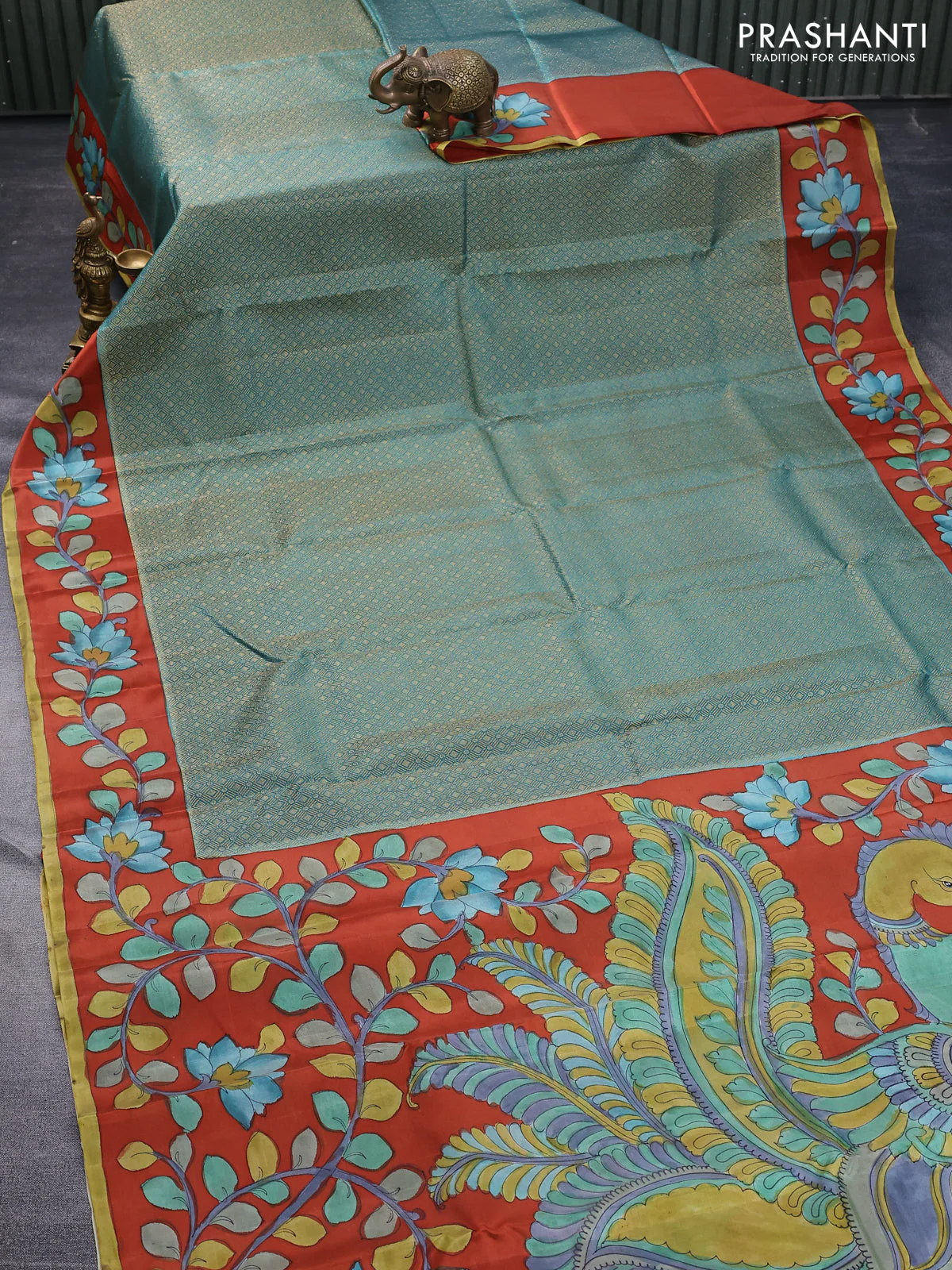 Pure kanchipuram silk saree teal green shade and rustic orange with allover zari woven geometric brocade weaves and kalamkari printed pallu & border - Image 2