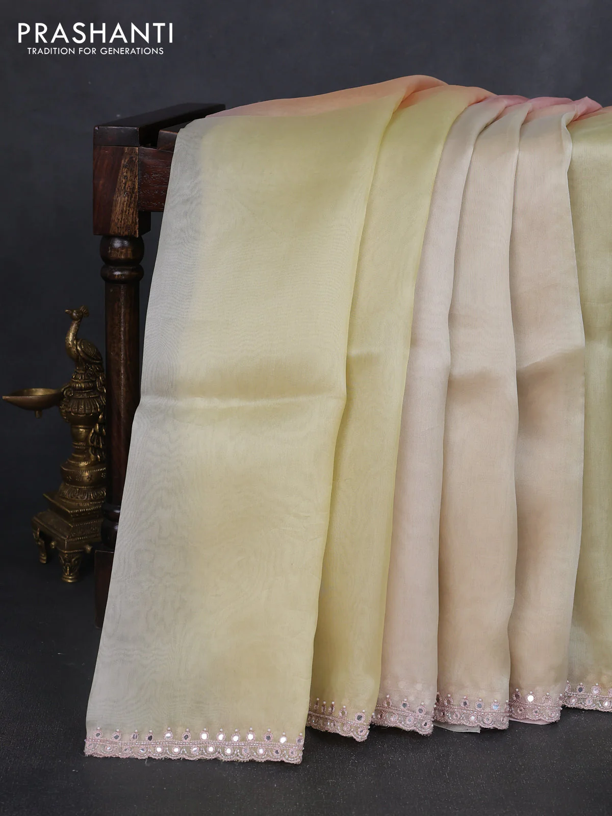 Pure organza silk saree pale yellow and peach with plain body and embroidery mirror work border