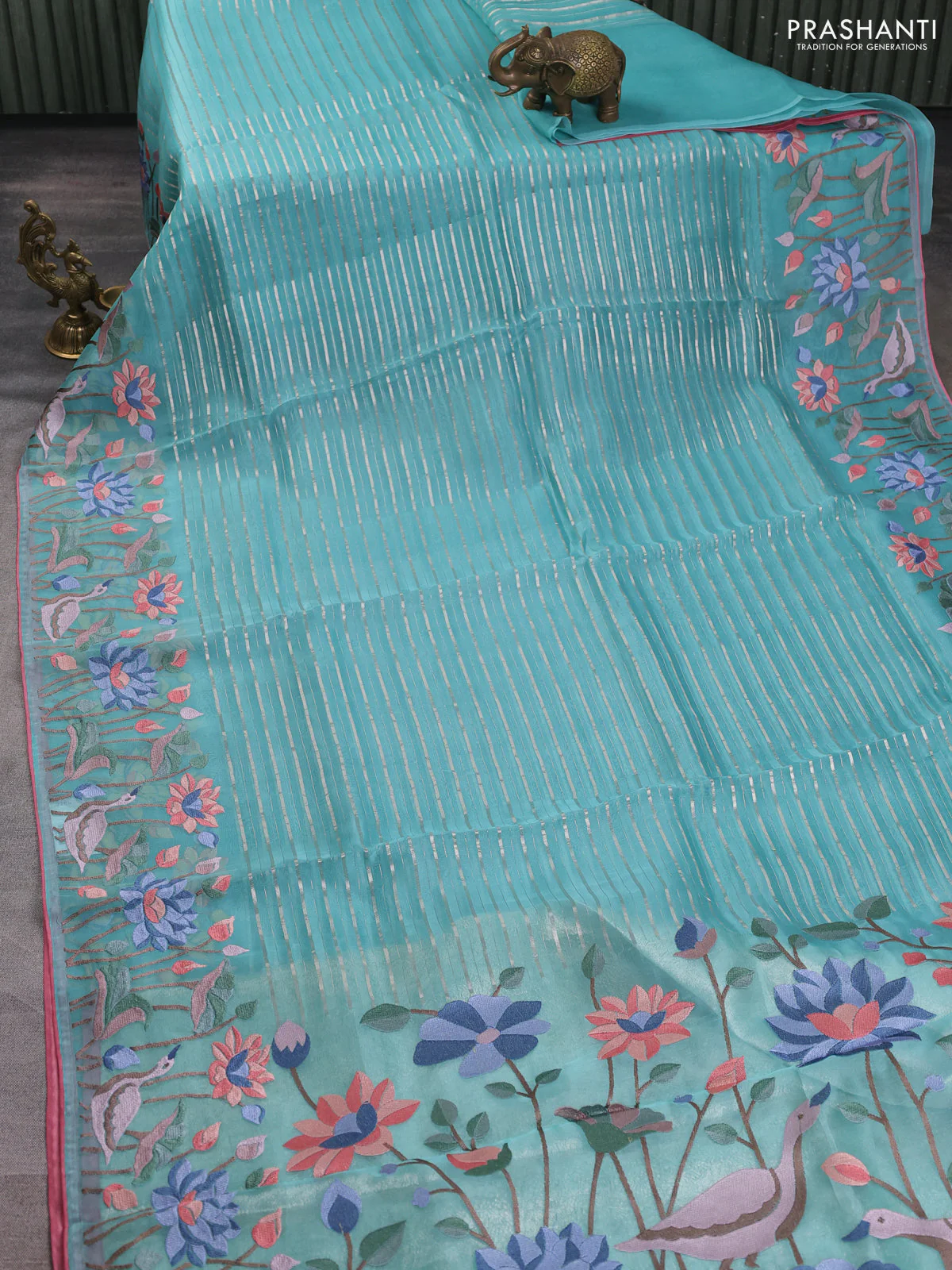 Pure organza silk saree teal green and peach pink with allover silver zari weaves and floral embroidery border - Image 2