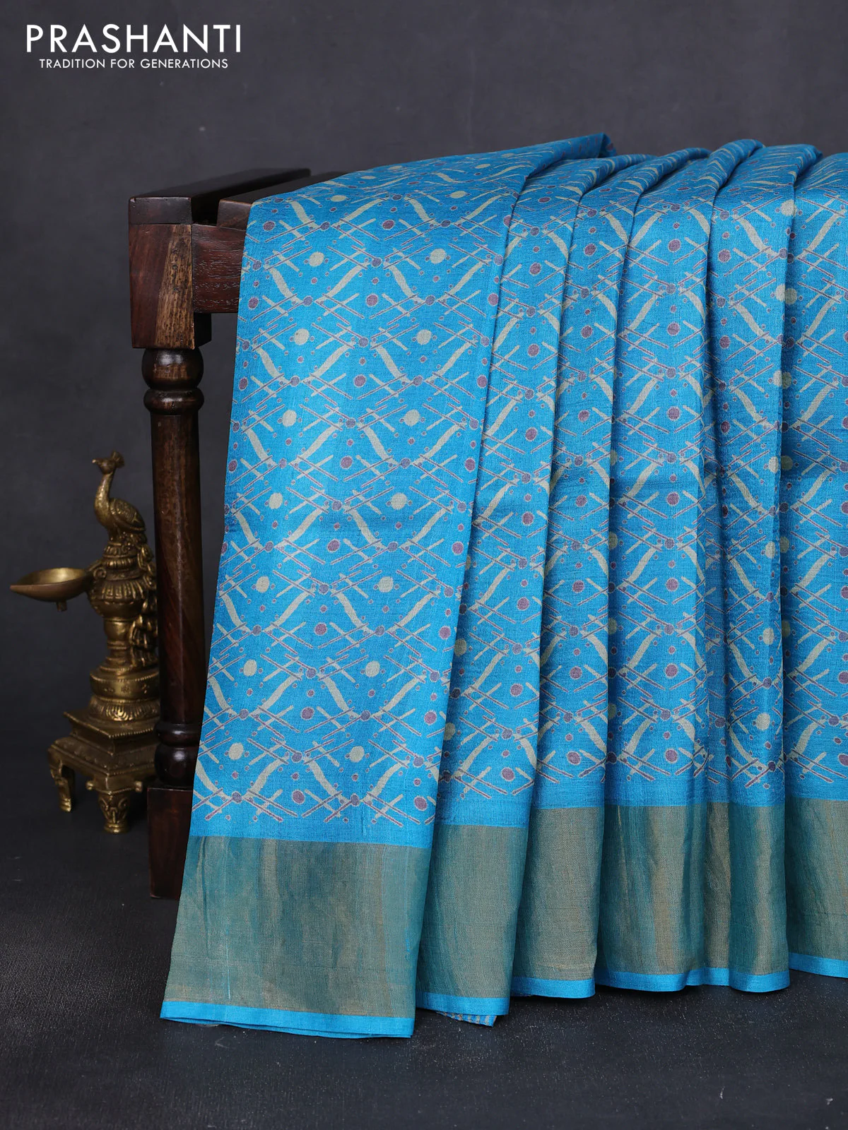 Pure tussar saree teal blue with allover prints and zari woven border
