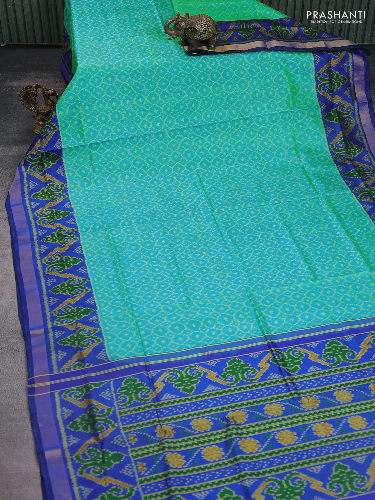 Rajkot patola silk saree dual shae of teal green and blue with allover ikat weaves and ikat woven border - Image 2
