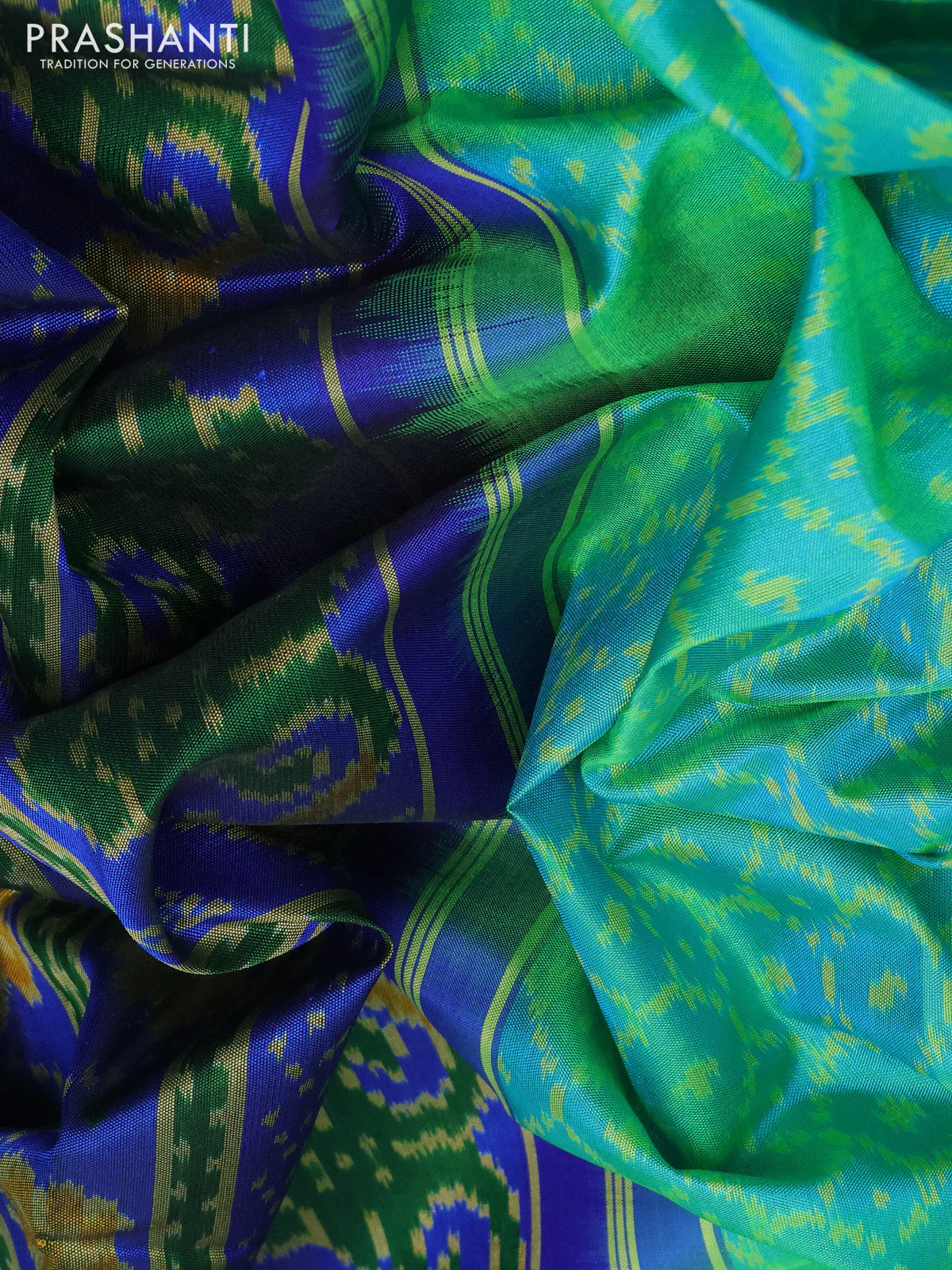 Rajkot patola silk saree dual shae of teal green and blue with allover ikat weaves and ikat woven border - Image 3