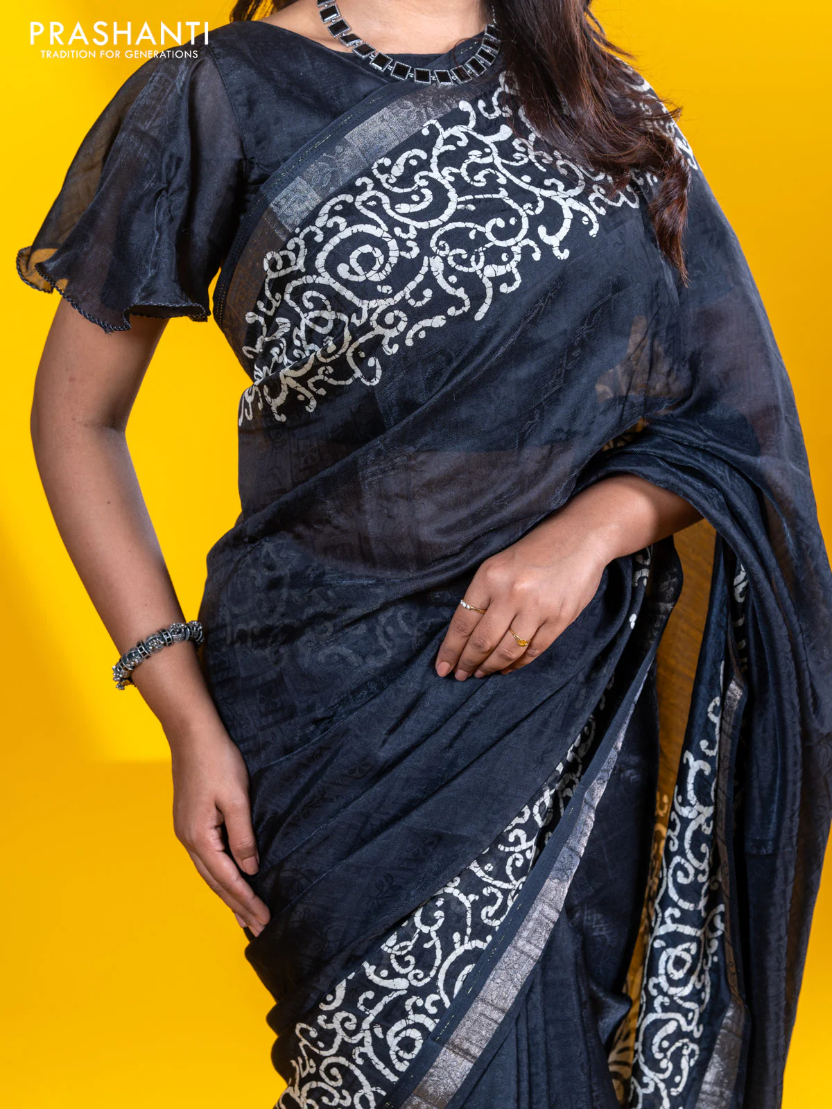 Semi crepe saree black with allover self emboss and batik printed border - Image 6