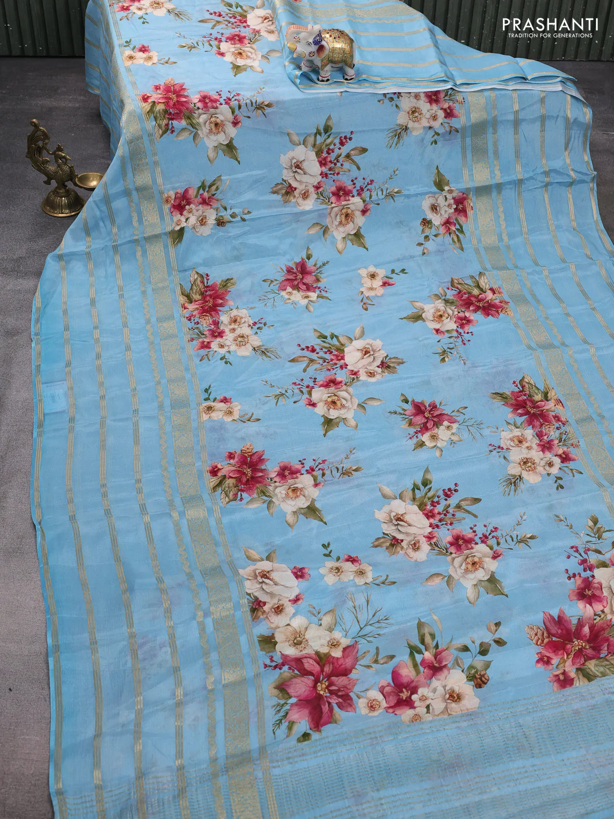 Semi georgette saree blue shade with allover floral prints and long zari woven border - Image 2