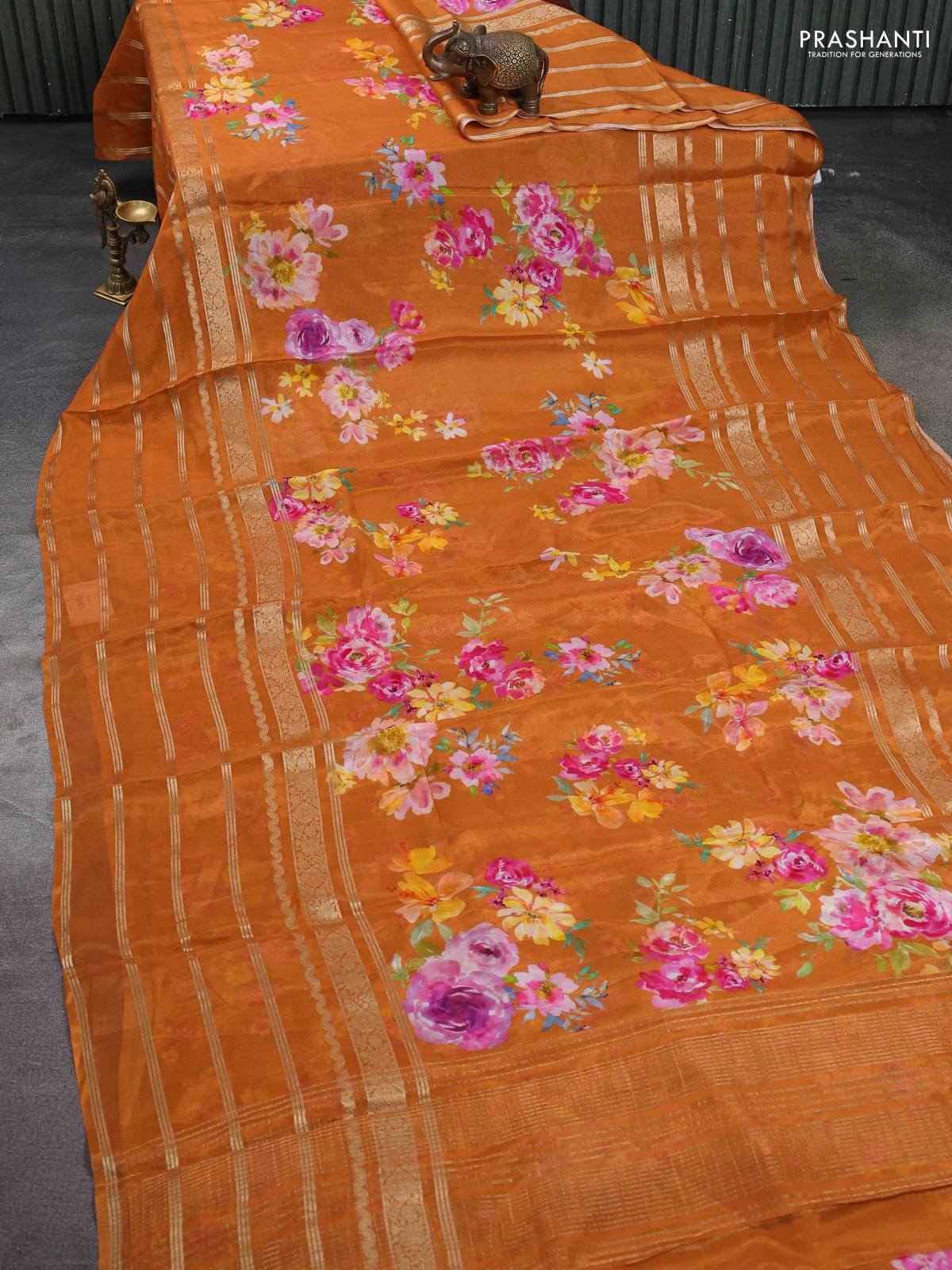 Semi georgette saree rustic orange with allover floral prints and long zari woven border - Image 2