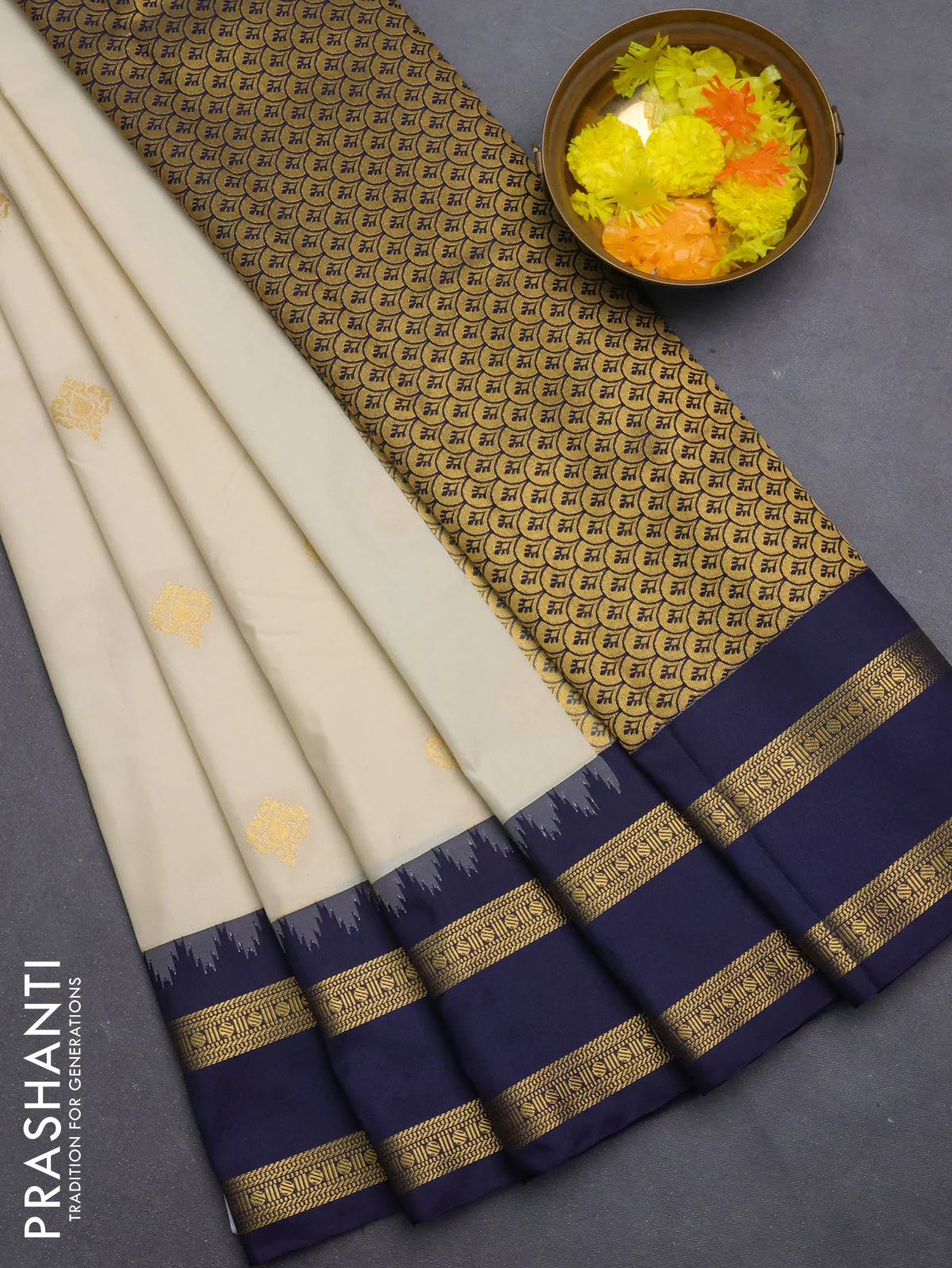 Semi kanchipuram silk saree cream and navy blue with zari woven buttas and temple design rettapet zari woven border