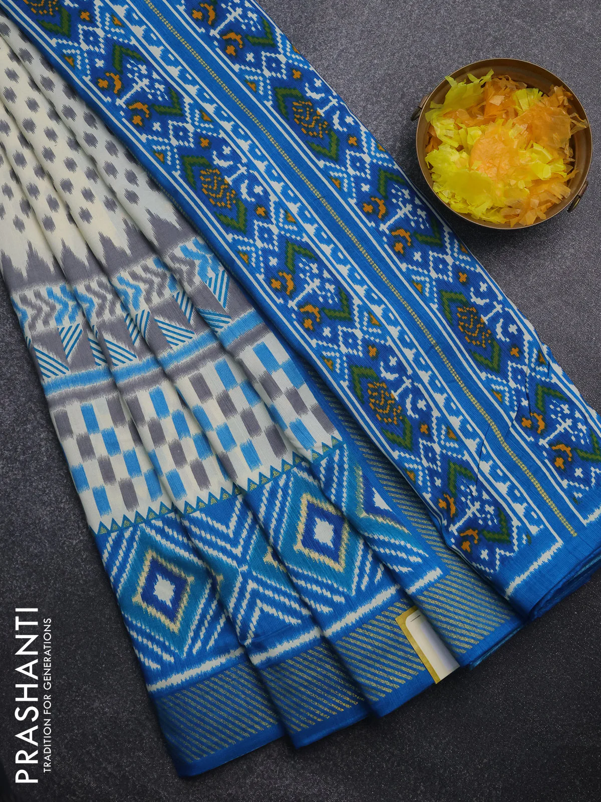 Semi patola saree off white and cs blue with allover ikat weaves and zari woven border