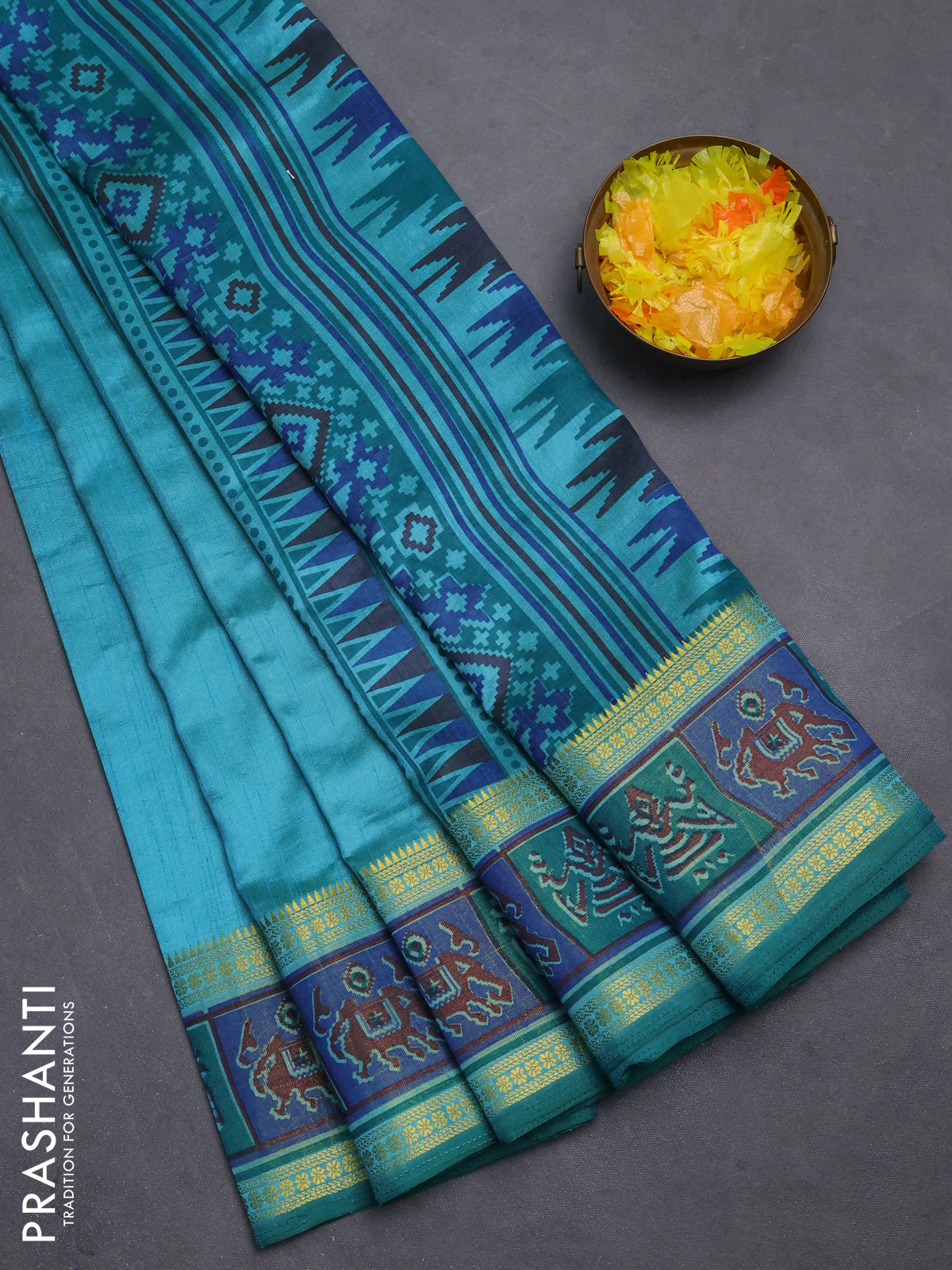 Semi tussar saree dual shade of teal blue with plain body and ikat woven zari border