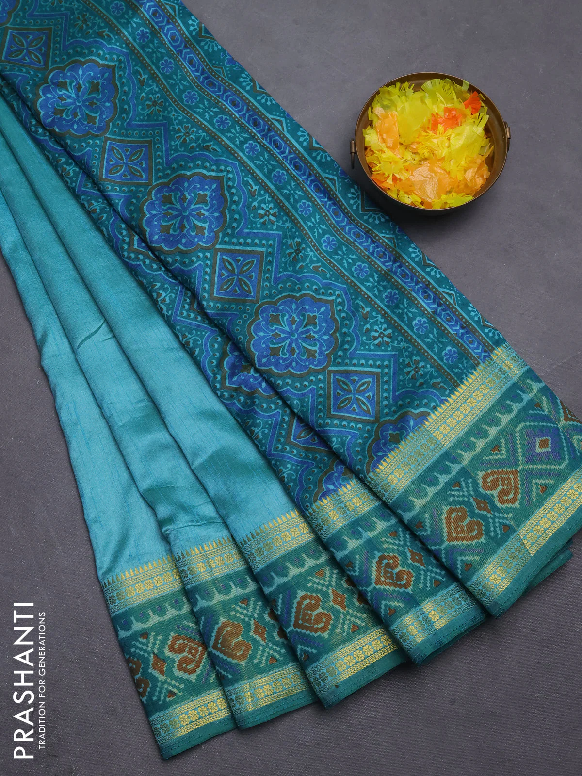 Semi tussar saree dual shade of teal blue with plain body and ikat woven zari border