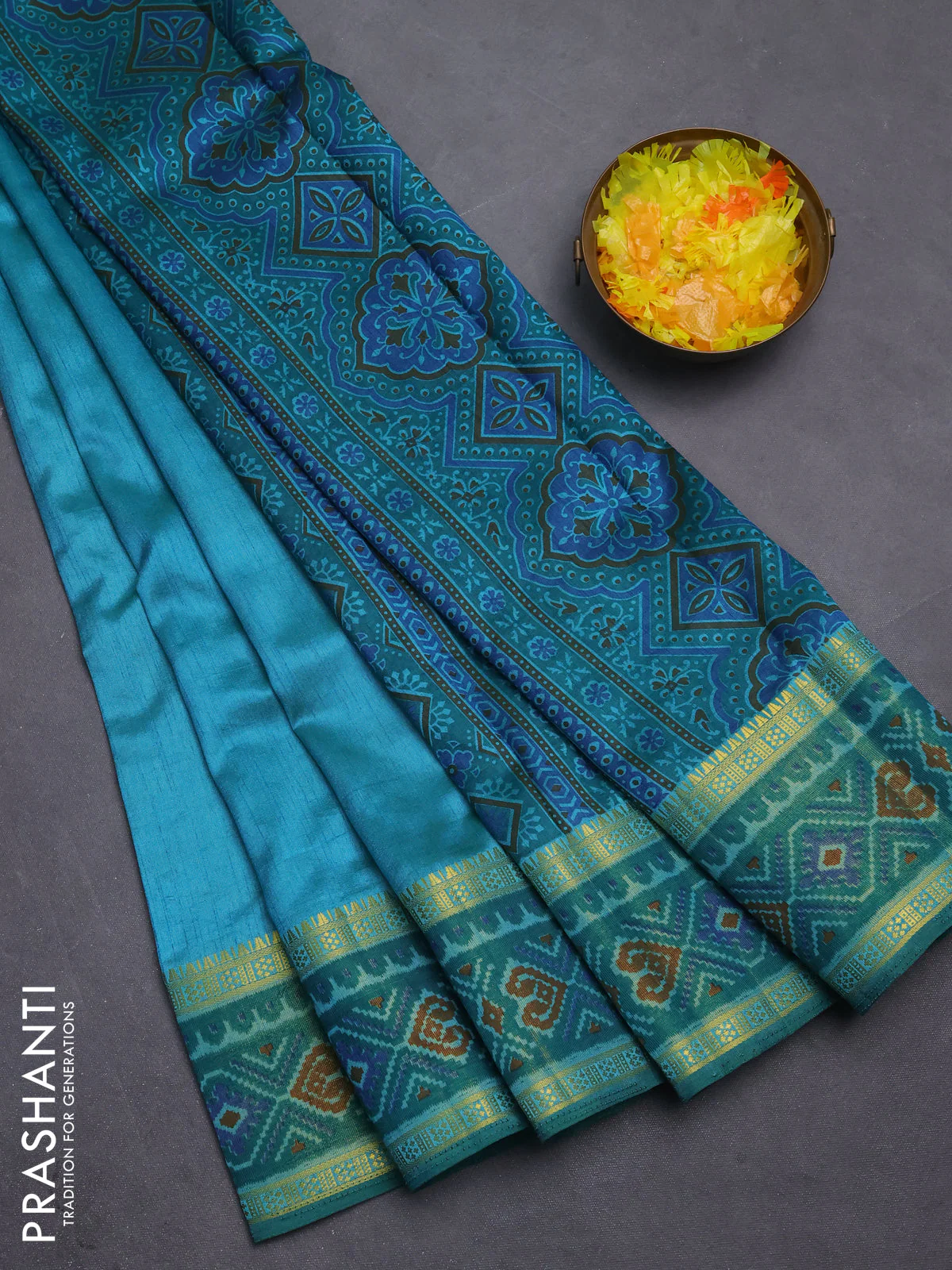 Semi tussar saree dual shade of teal blue with plain body and ikat woven zari border