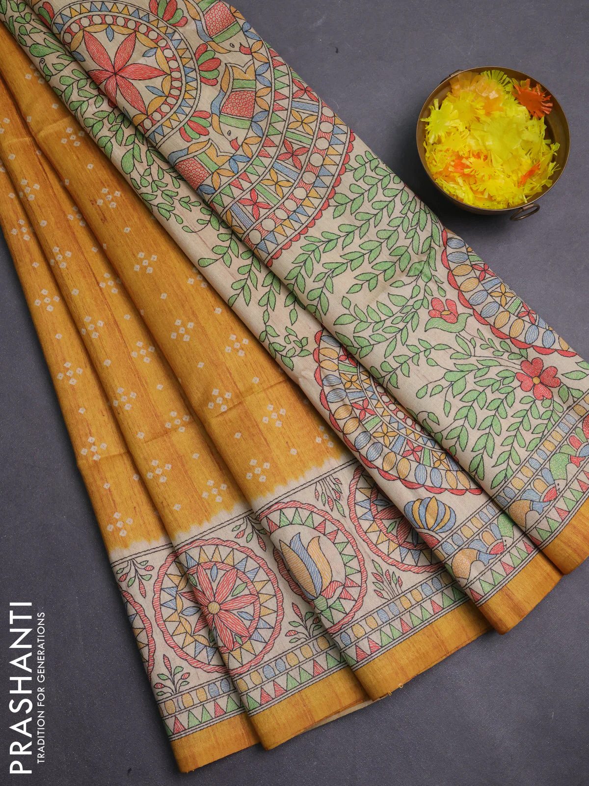 Semi tussar saree mustard yellow and beige with allover bandhani prints and madhubani printed pallu & border