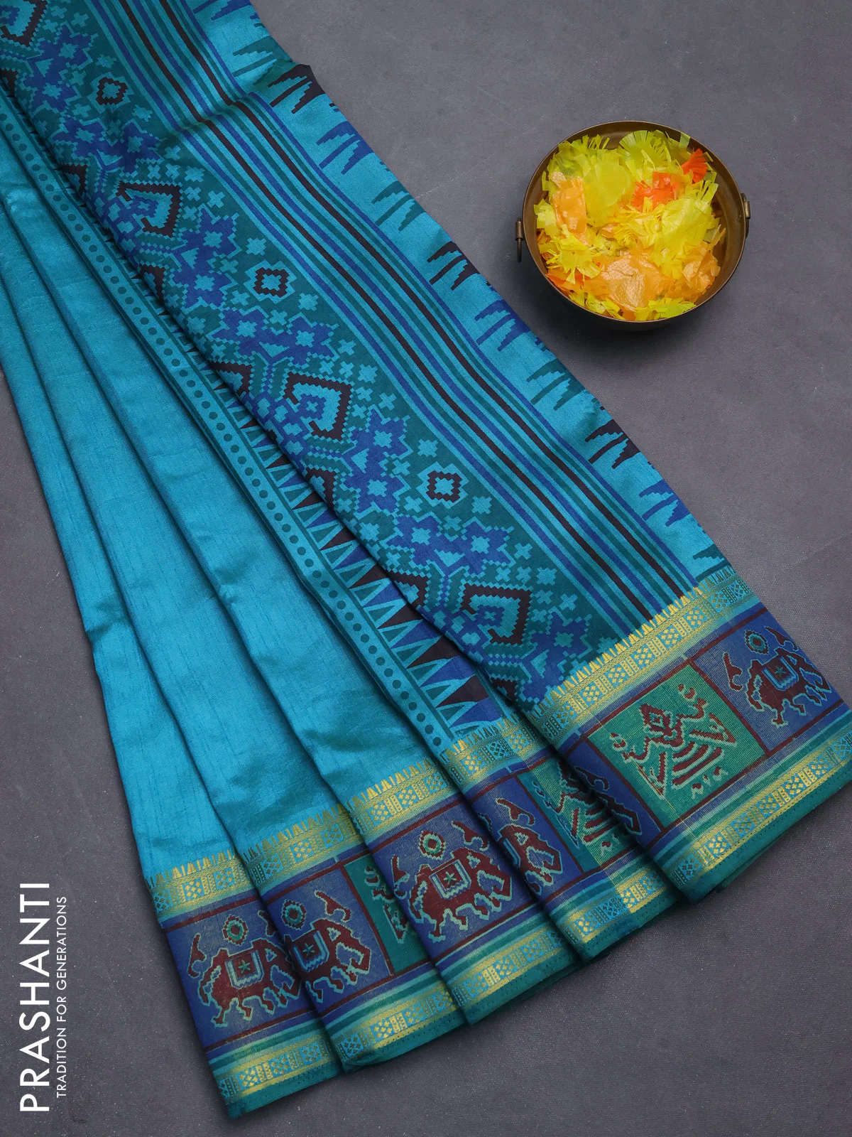 Semi tussar saree teal blue with plain body and ikat woven zari border