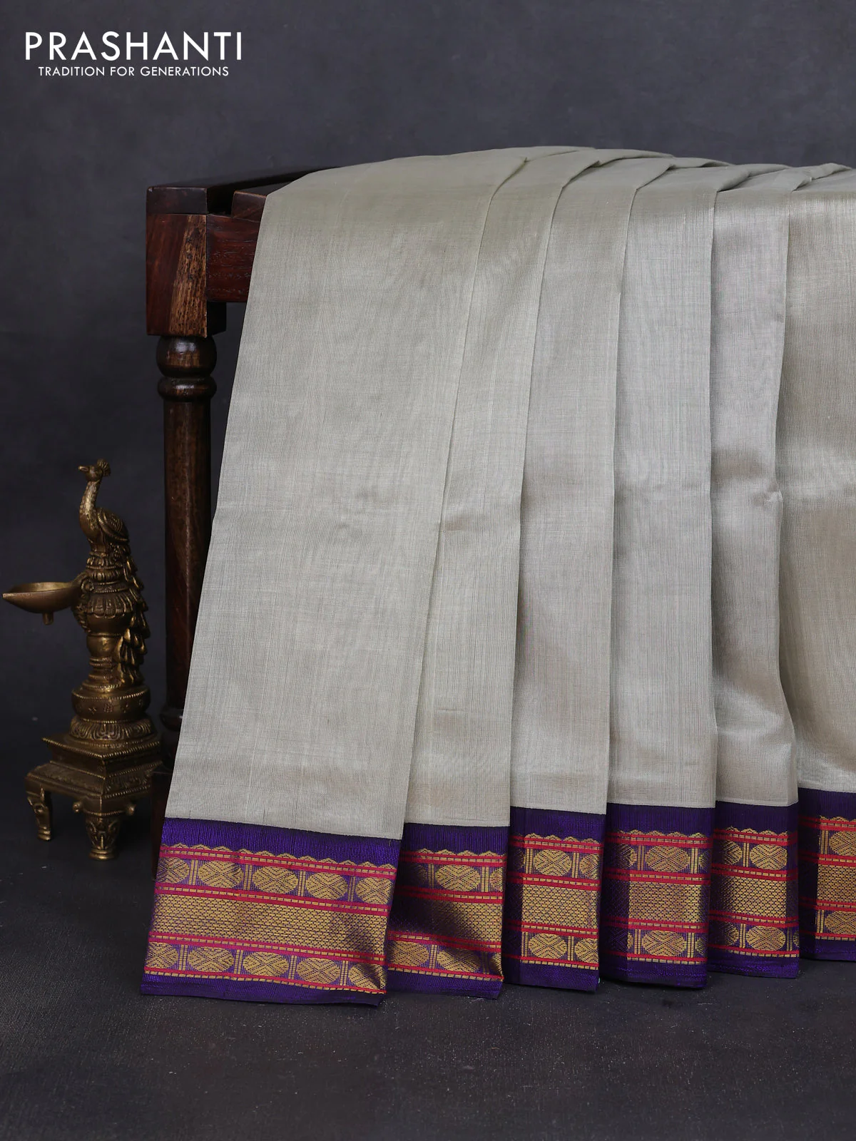 Silk cotton saree beige and blue with plain body and zari woven korvai border
