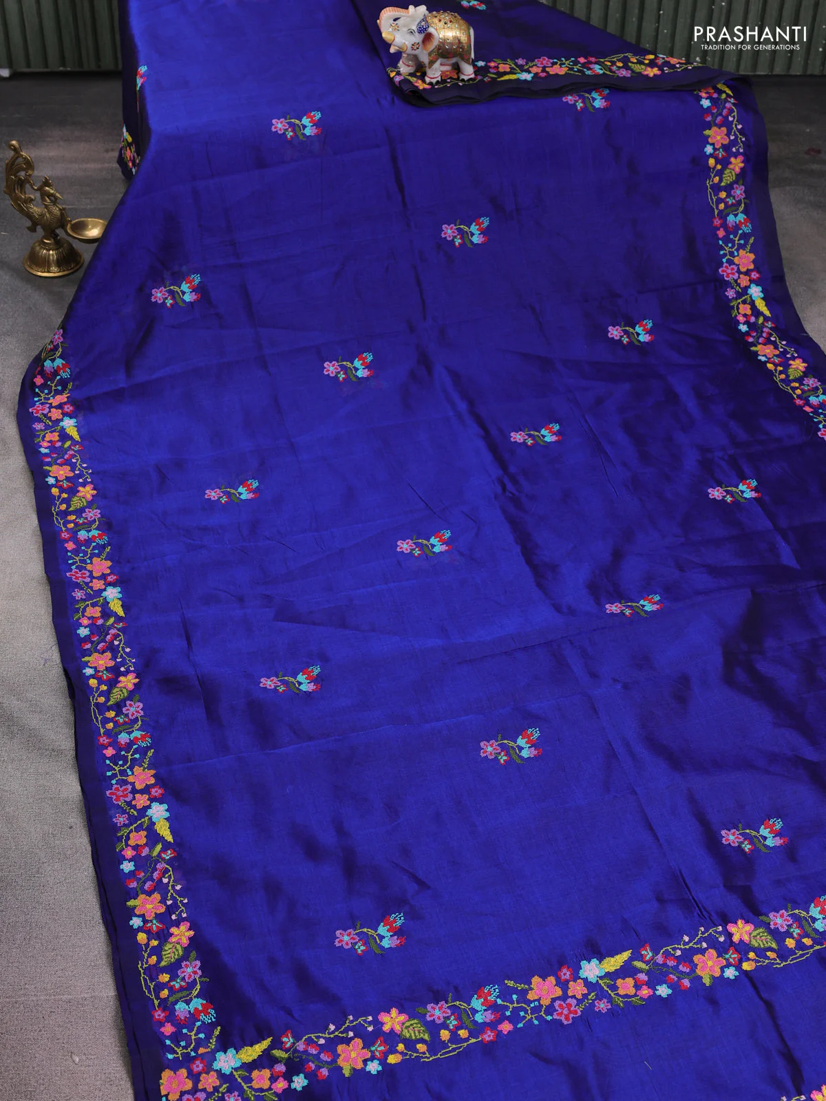 Silk cotton saree blue with floral embroidery buttas and embroidery border