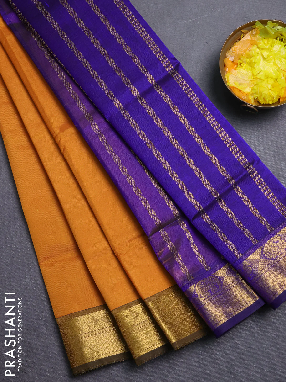 Silk cotton saree dark mustard and blue with plain body and zari woven border