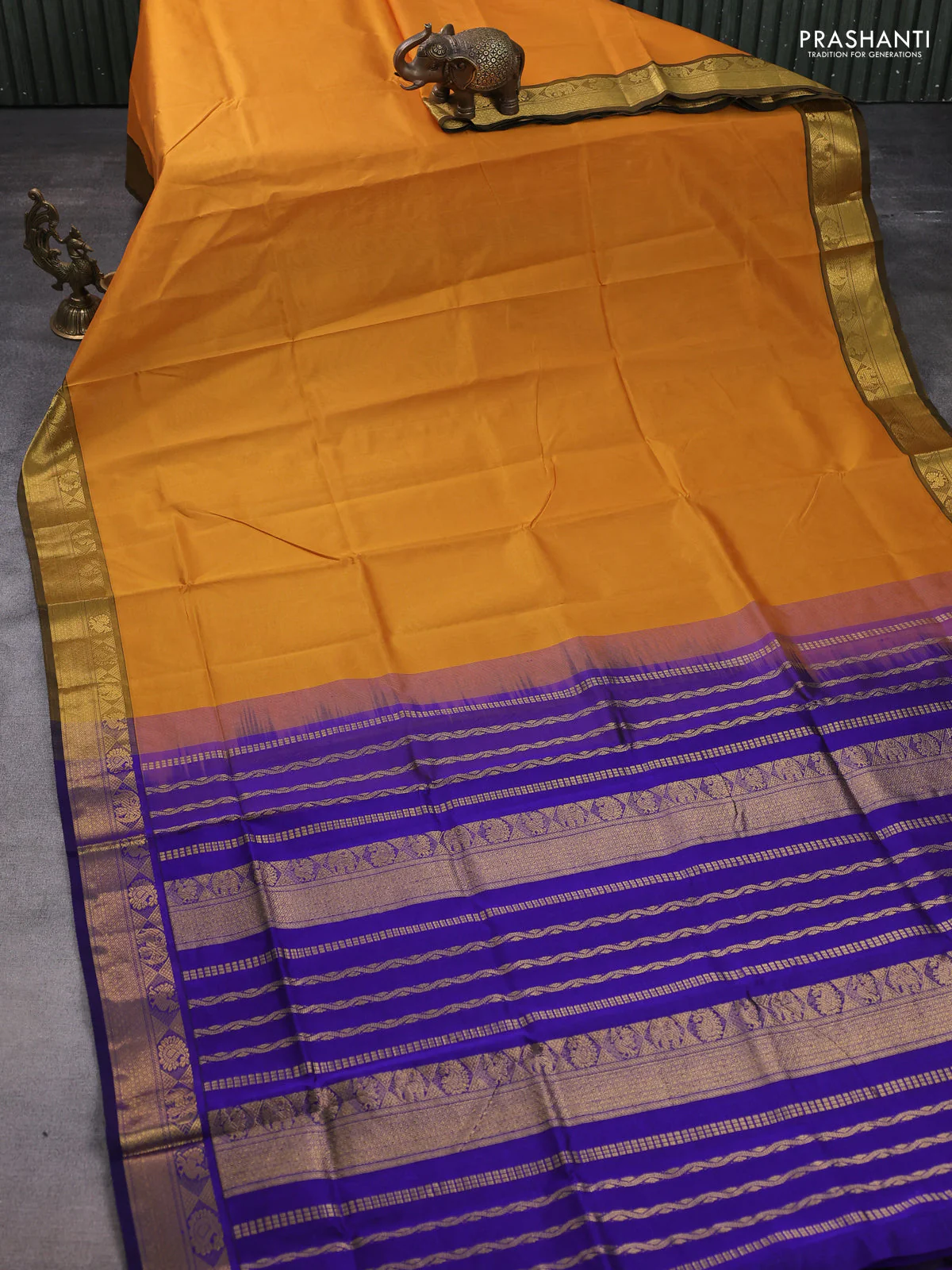Silk cotton saree dark mustard and blue with plain body and zari woven border - Image 2